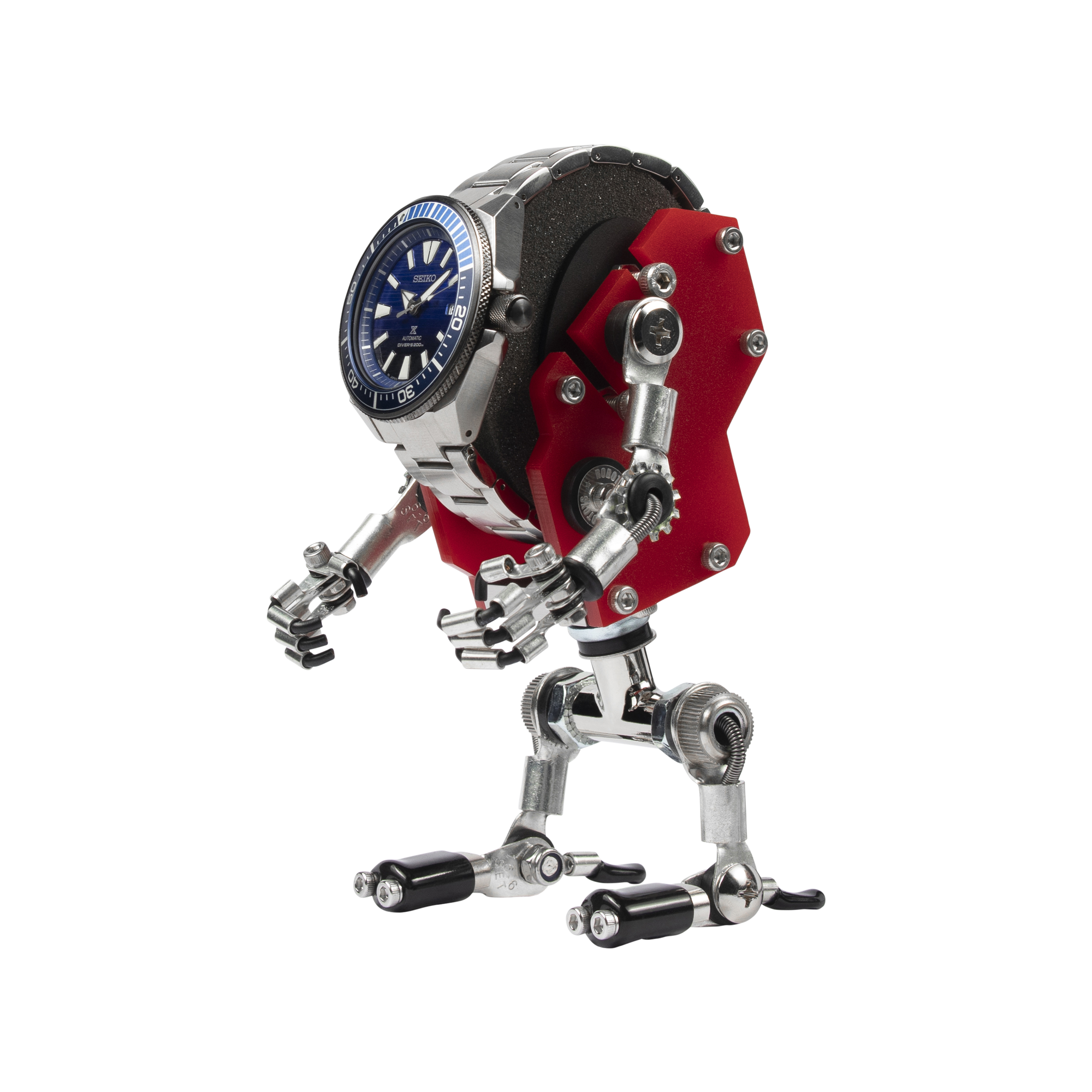 Red robotic watch stand with mechanical arms and legs holding silver dive watch with blue dial