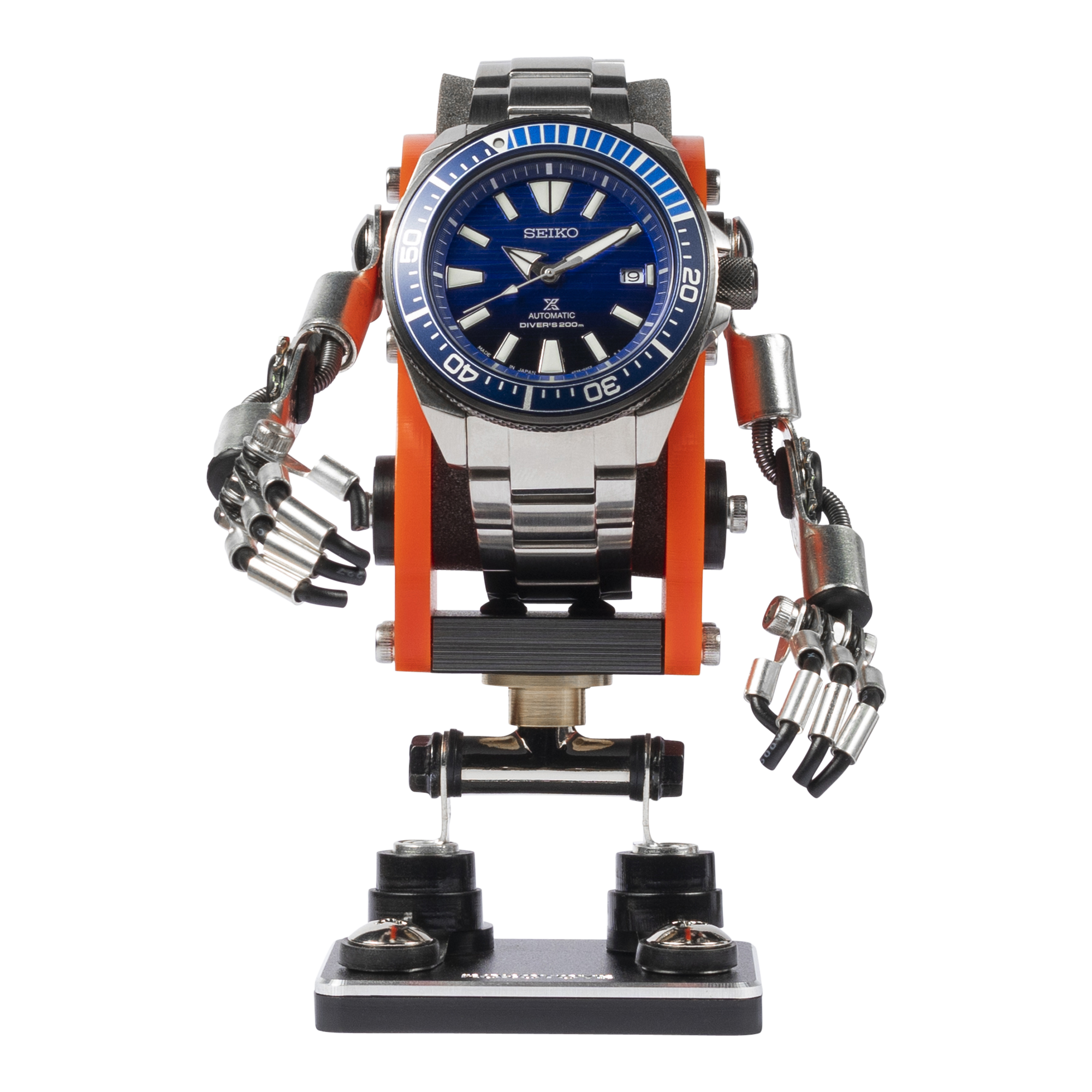 Seiko automatic diver's watch mounted on orange and black robot-shaped watch stand with articulated arms and legs
