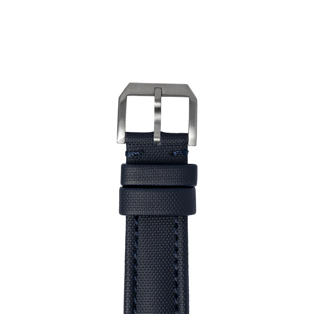 Navy blue sailcloth quick release watch band with brushed metal buckle and contrast stitching