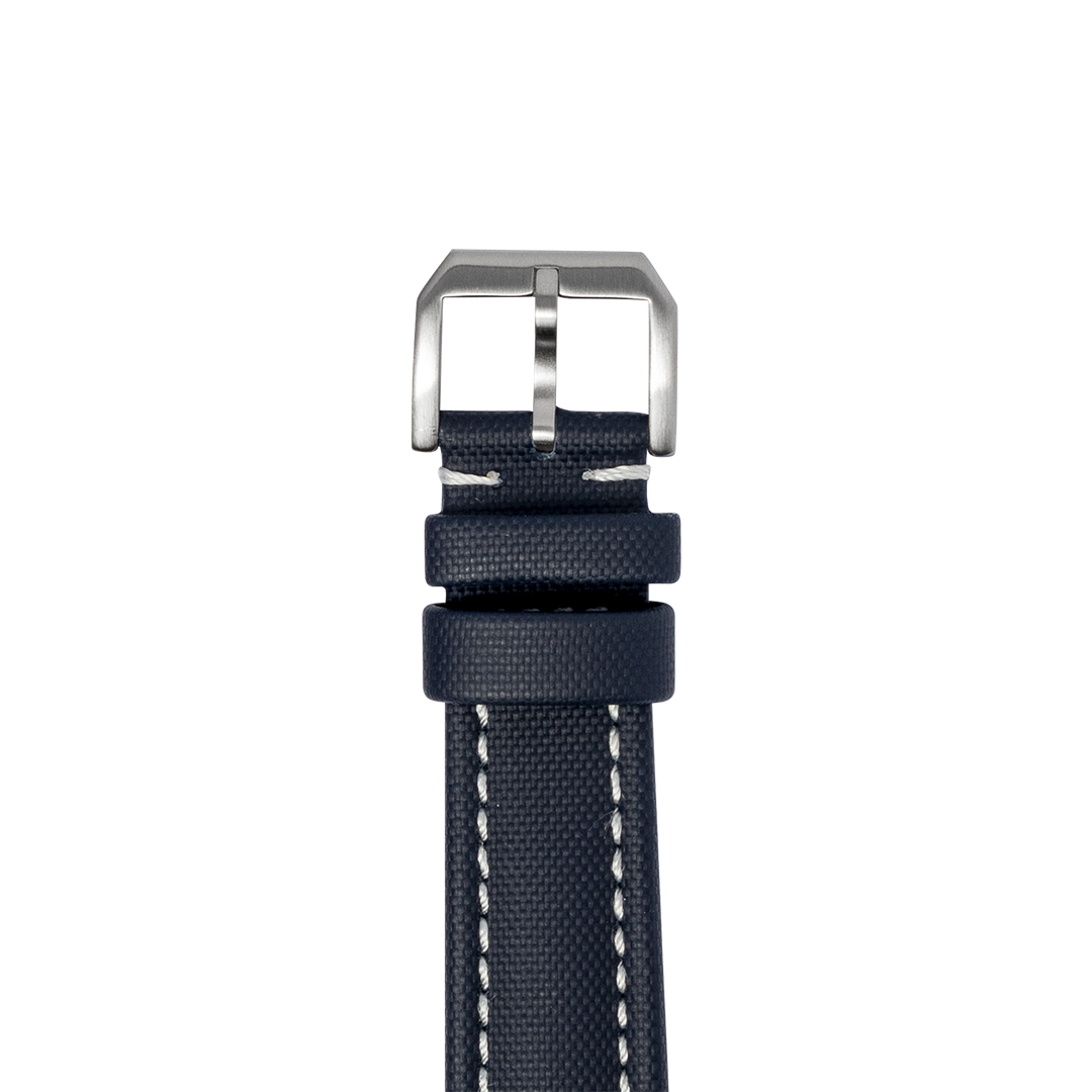 Navy blue sailcloth watch strap with quick release mechanism and brushed steel buckle