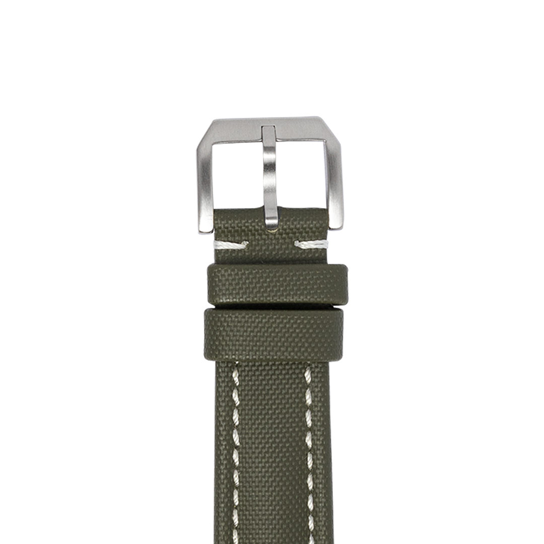 Olive green canvas watch strap with quick release pins and brushed steel buckle, white stitching detail