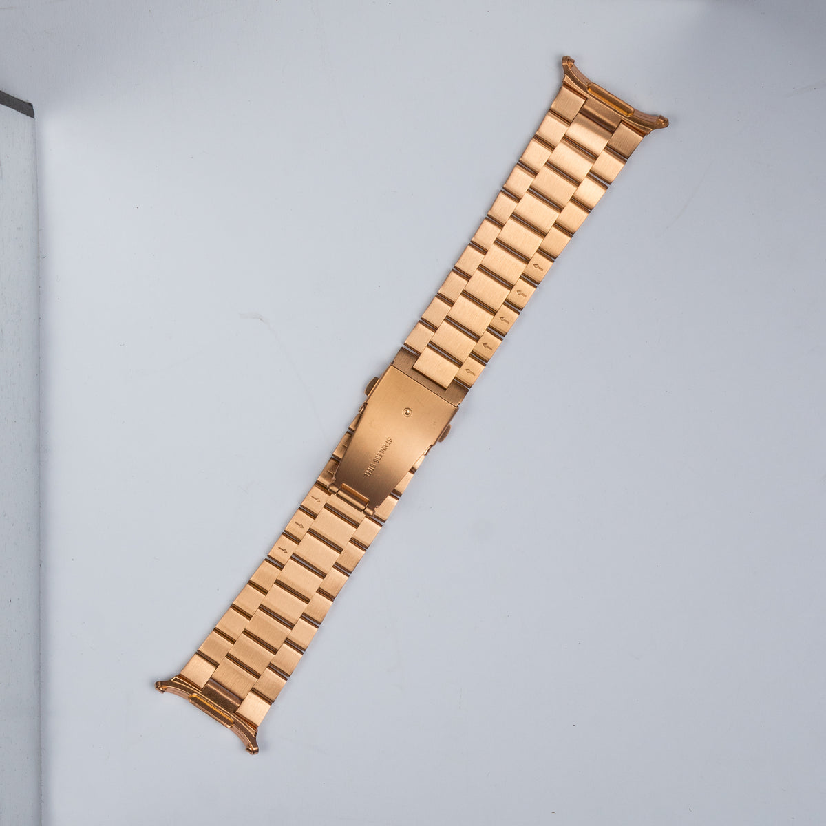 Rose gold stainless steel smartwatch band with link bracelet design and deployment clasp