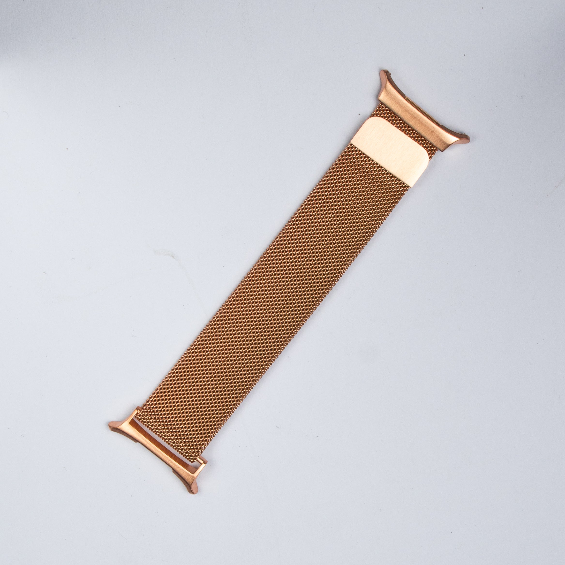 Rose gold Milanese mesh smartwatch band with magnetic closure and connector lugs