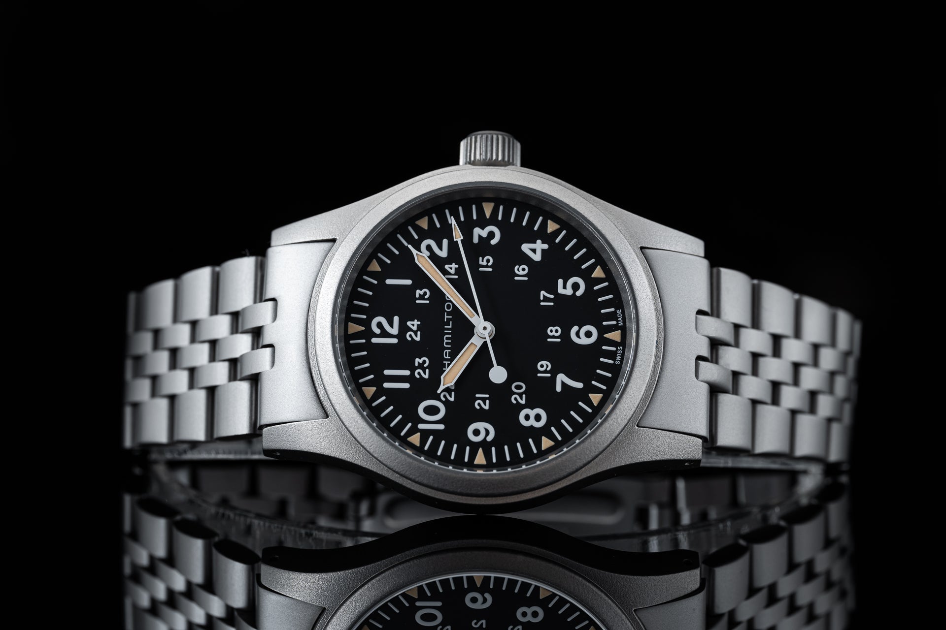 Hamilton Khaki mechanical watch 38mm with black dial, silver steel bracelet and date window on black background