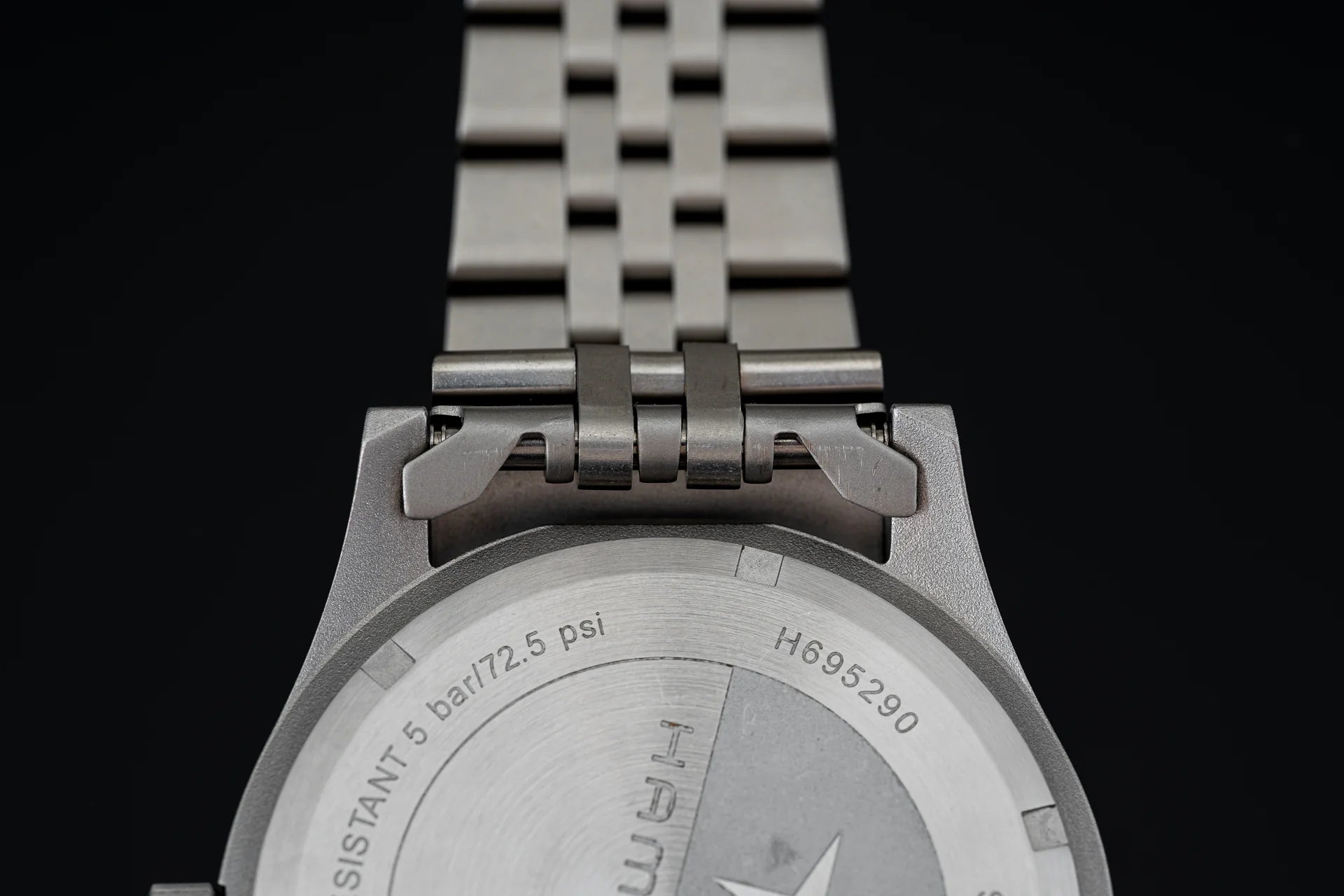 Hamilton Khaki mechanical watch with stainless steel bracelet and caseback showing 5 bar water resistance rating