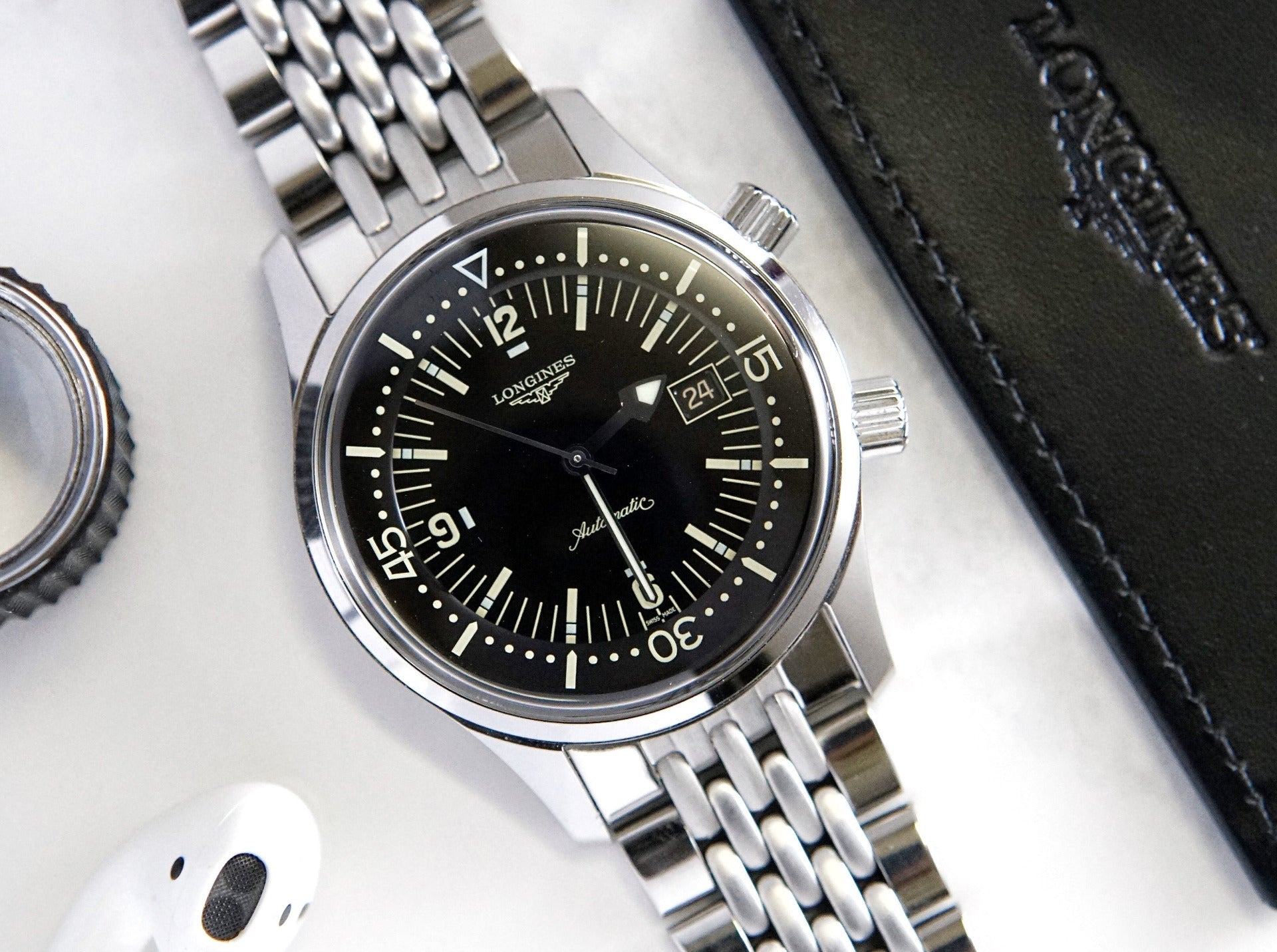 Longines Legend automatic watch with black dial, stainless steel Beads of Rice bracelet, date window, and vintage military-style design