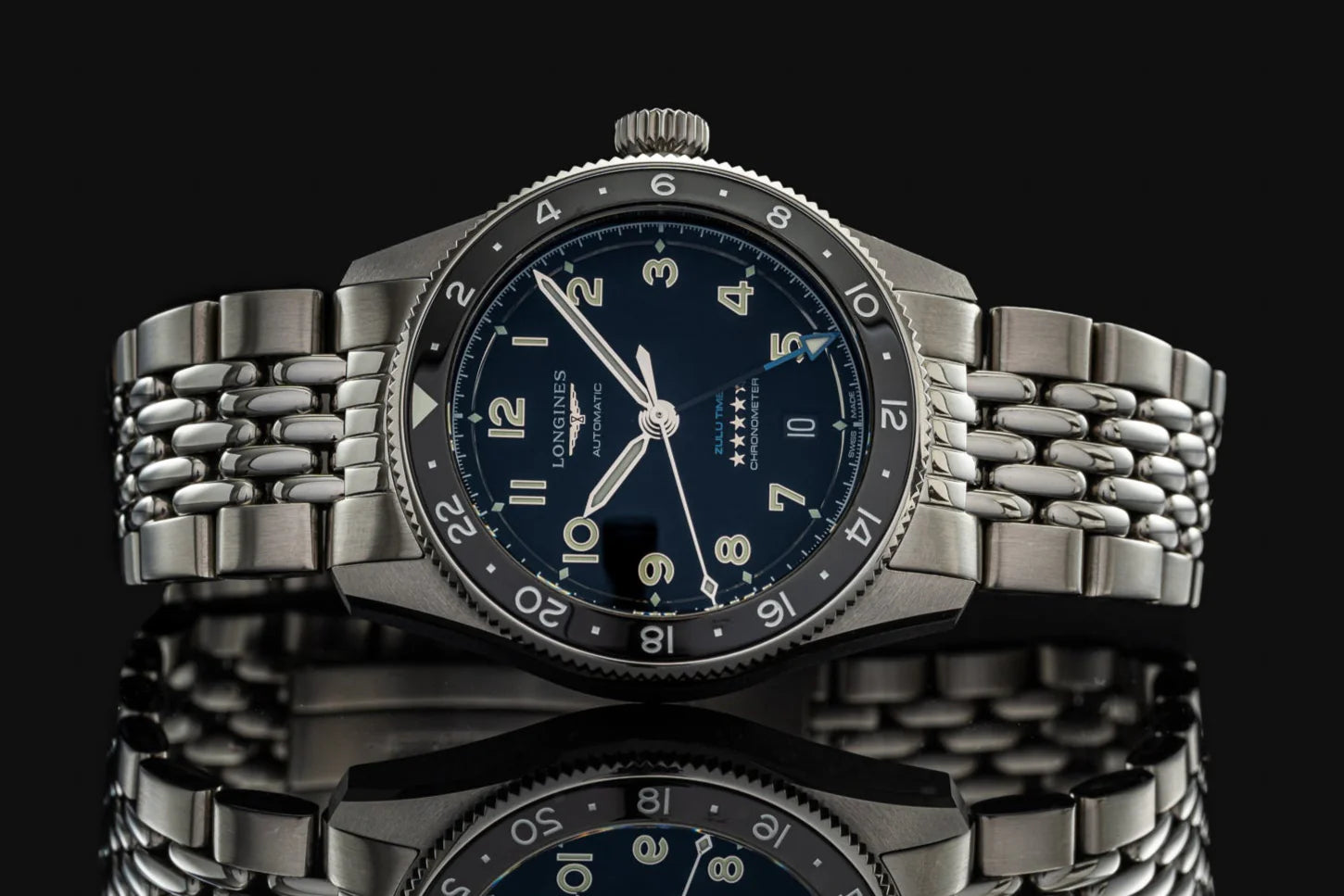 Longines Spirit Zulu Time 39mm automatic watch with stainless steel beads of rice bracelet and black dial on black background