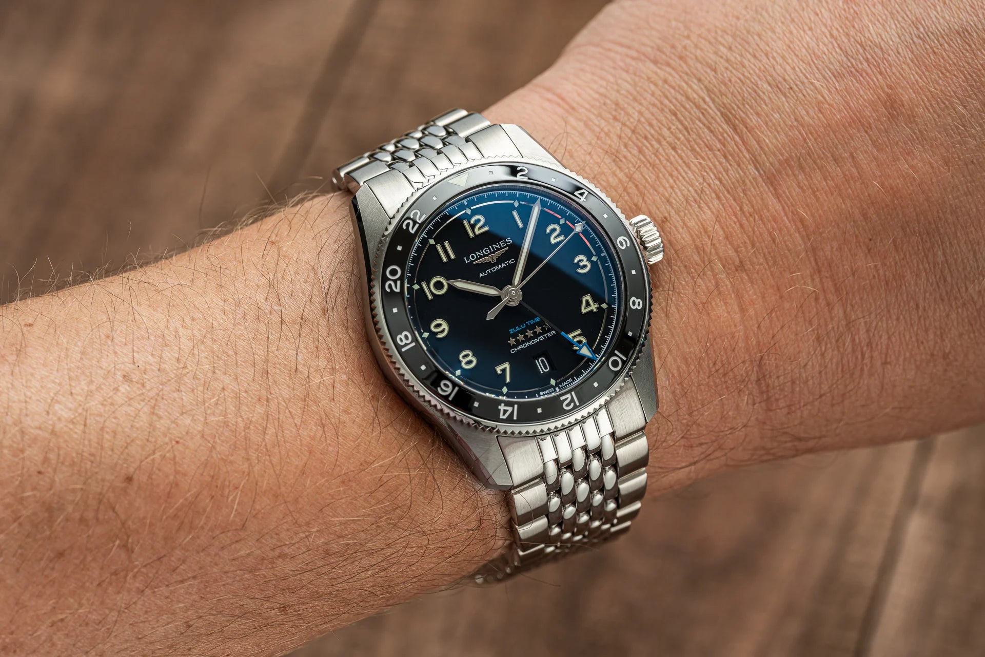 Longines Spirit Zulu Time 39mm automatic watch with black dial, steel bracelet and rotating GMT bezel on wrist