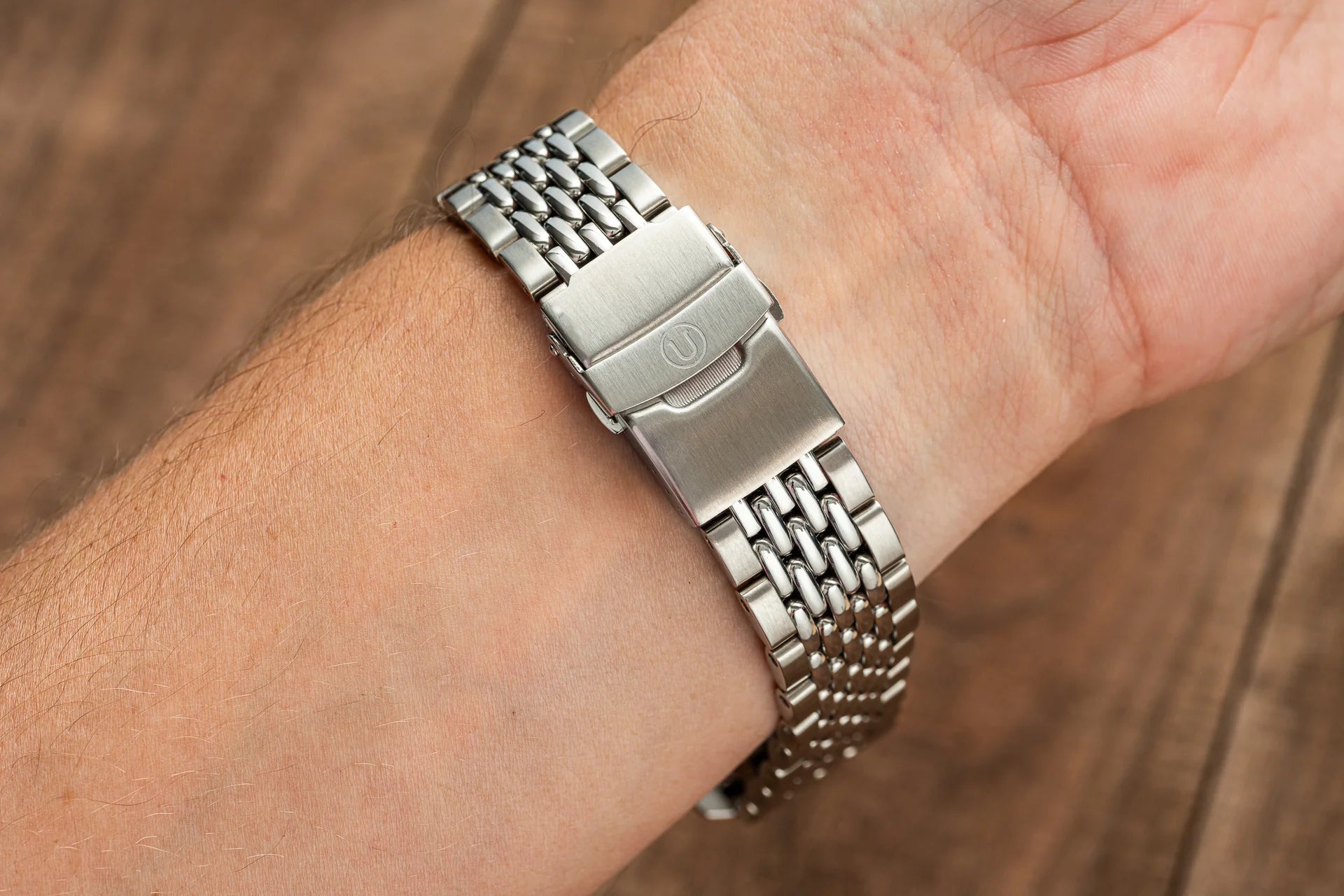 Stainless steel beads of rice bracelet worn on wrist, matching Longines Spirit Zulu Time 39mm watch with brushed clasp