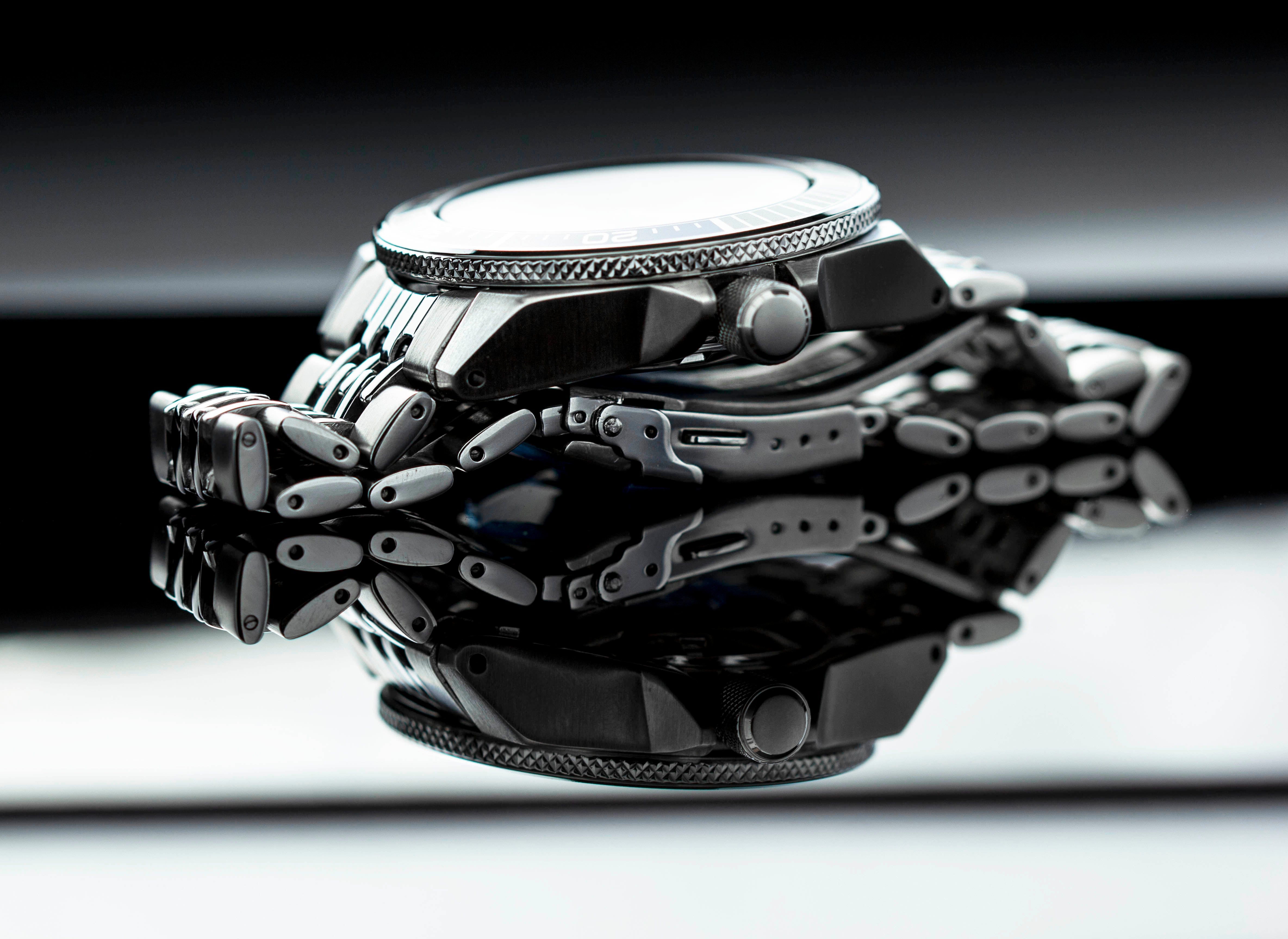 Silver beads of rice bracelet with metal links displayed on Seiko Samurai dive watch with white dial and textured bezel