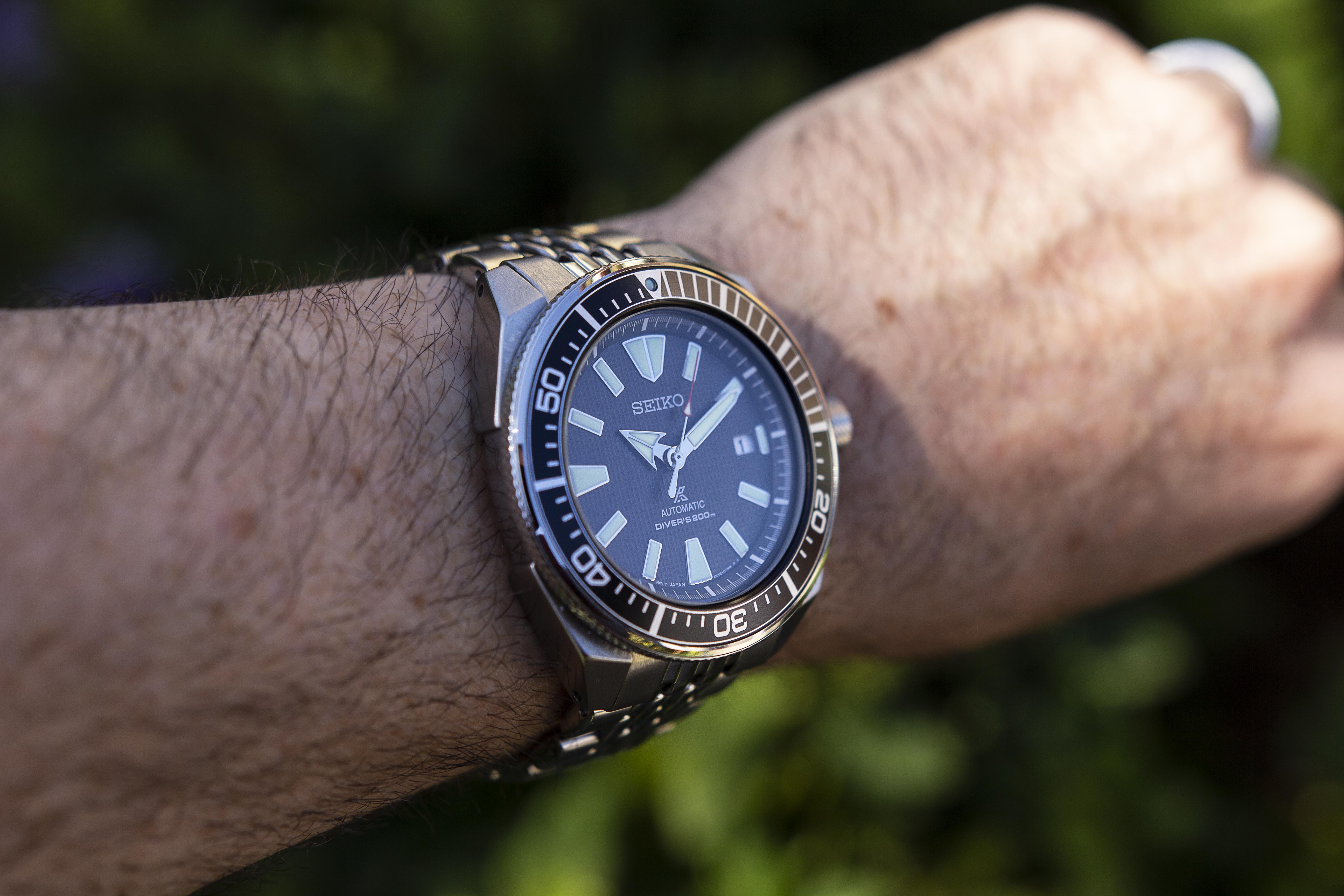 Seiko Samurai automatic diver watch with blue dial, stainless steel bracelet, worn on wrist outdoors