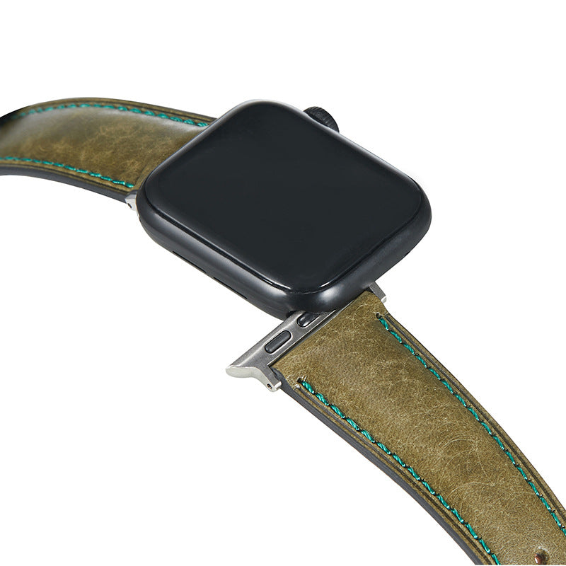 Black smartwatch with tan leather strap featuring turquoise stitching and stainless steel connector