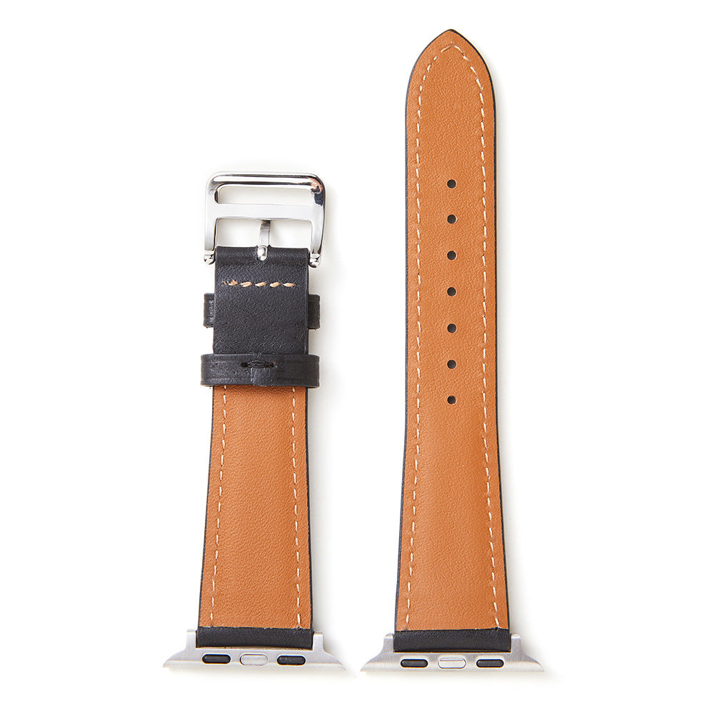 Tan leather Apple Watch band with black leather trim, contrasting white stitching, and stainless steel buckle