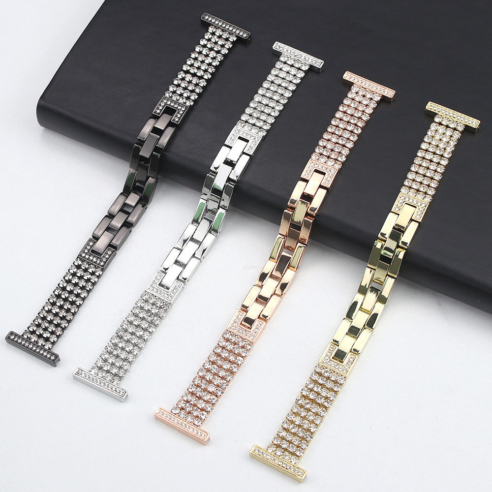 Diamond-encrusted Apple Watch bands in black, silver, rose gold, and gold finishes displayed on black leather background