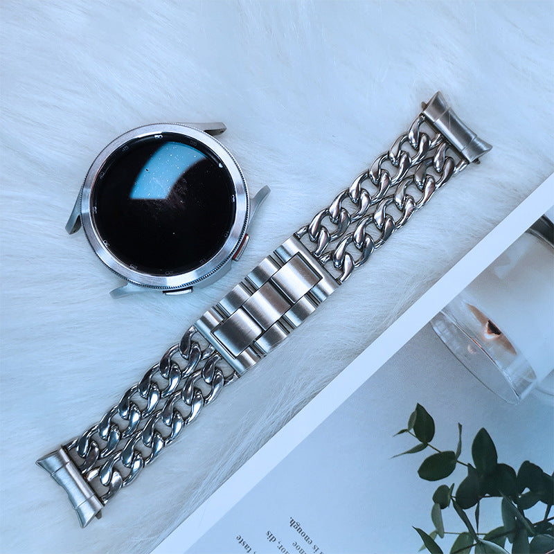 Stainless steel chain link bracelet with mixed link design for Galaxy Watch 4-7, shown with watch case and blue accent lighting