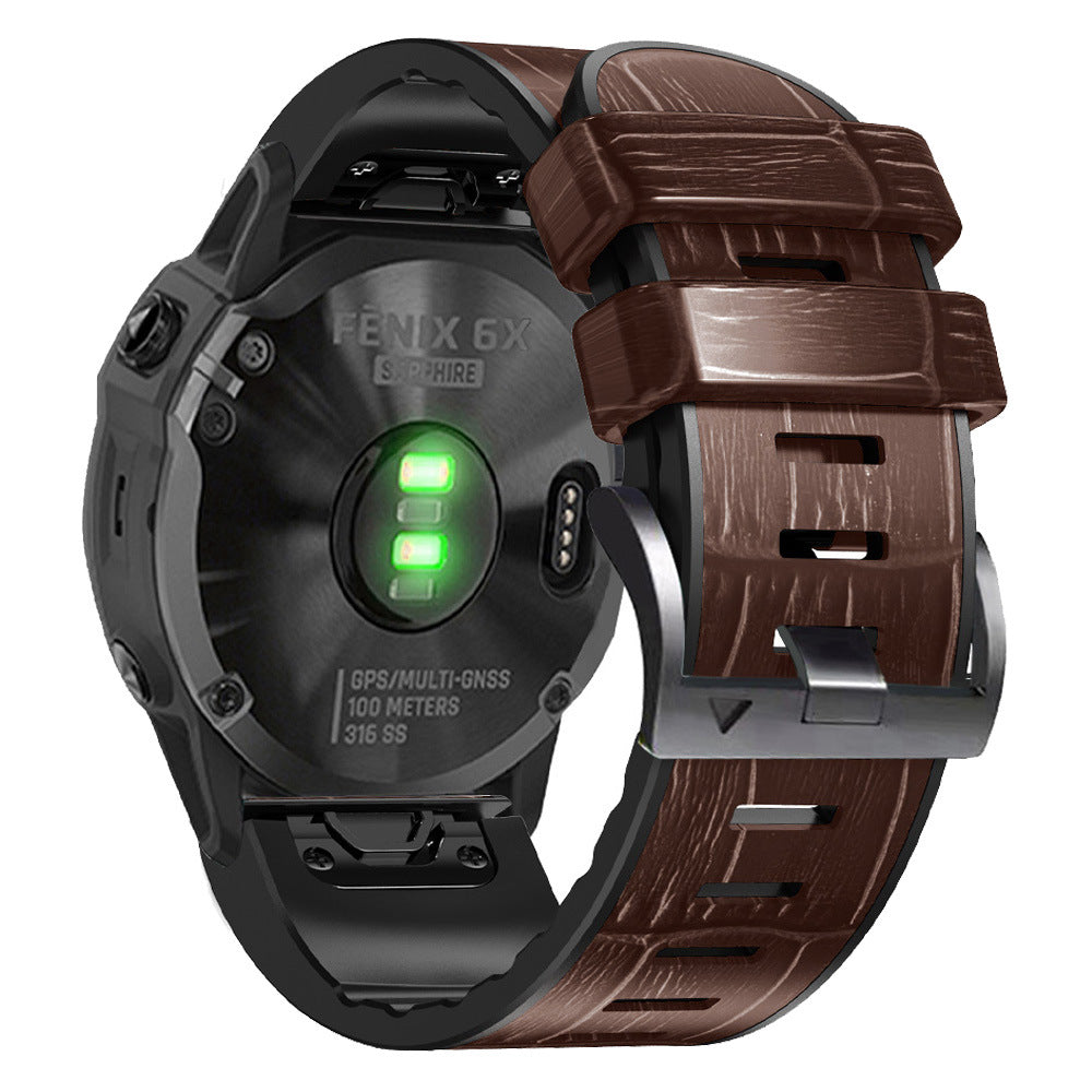 Garmin Fenix 6X smartwatch with black case and brown alligator leather QuickFit band showing green battery indicator