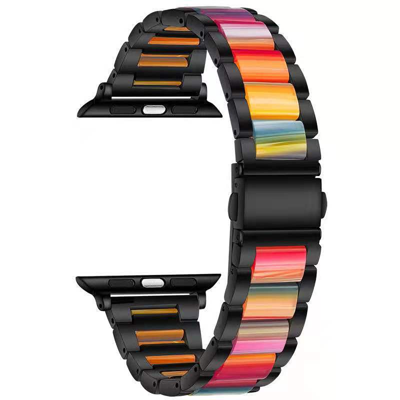 Colorful pearlescent Apple Watch band with gradient rainbow stripes and black stainless steel links, shown on watch face