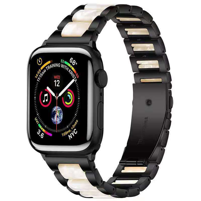 Black smartwatch with pearlescent white and gold stainless steel link bracelet featuring colorful activity rings on display