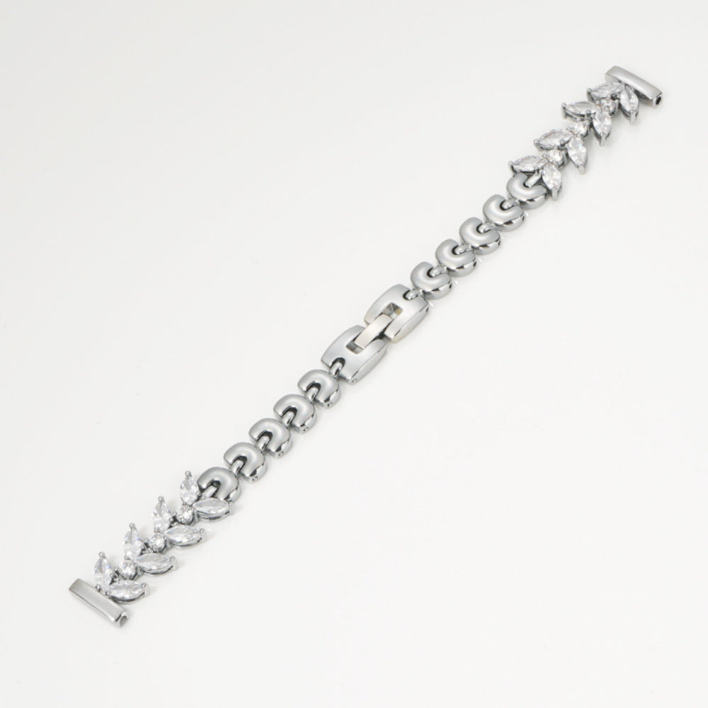 Silver tennis bracelet with marquise cubic zirconia stones and quick release clasp on white background