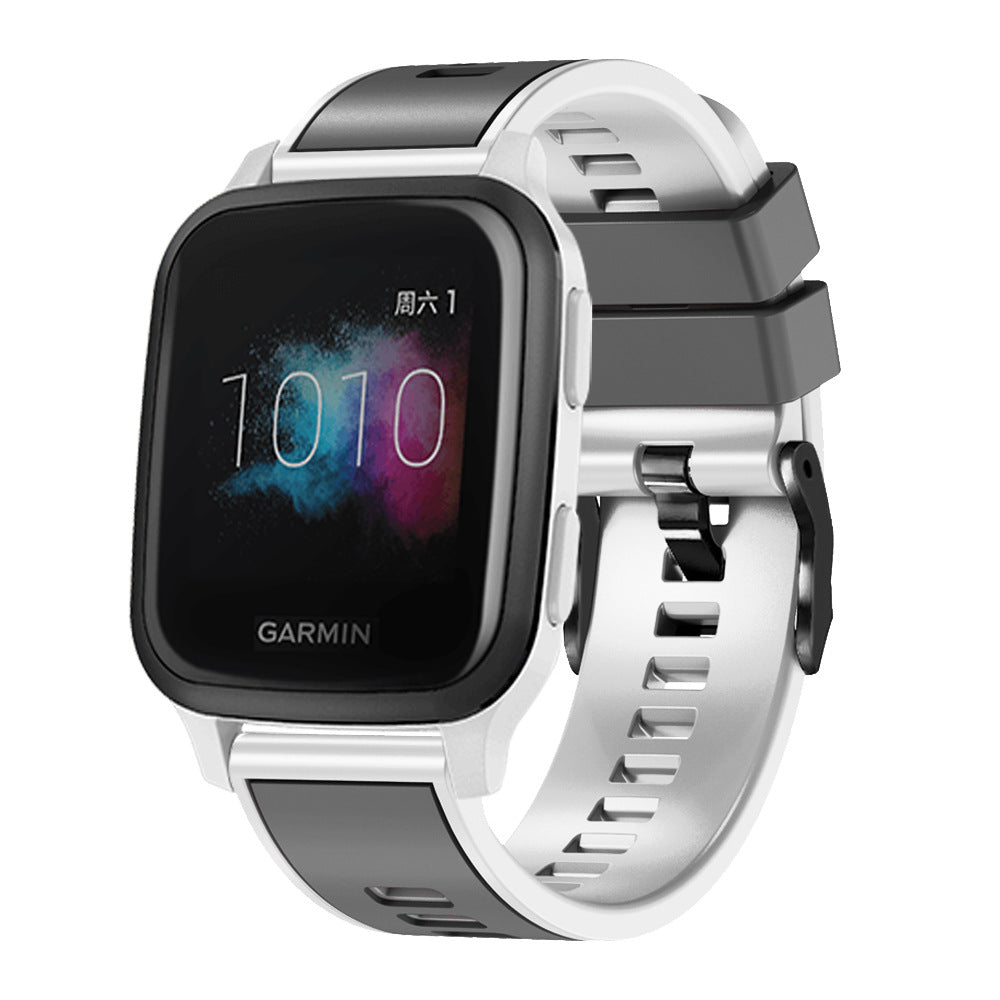 Garmin smartwatch with white and black two-tone silicone band featuring quick release mechanism and black hardware