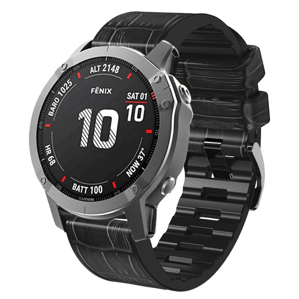 Fenix smartwatch with silver case, black digital display showing date and battery level, featuring QuickFit alligator leather hybrid strap