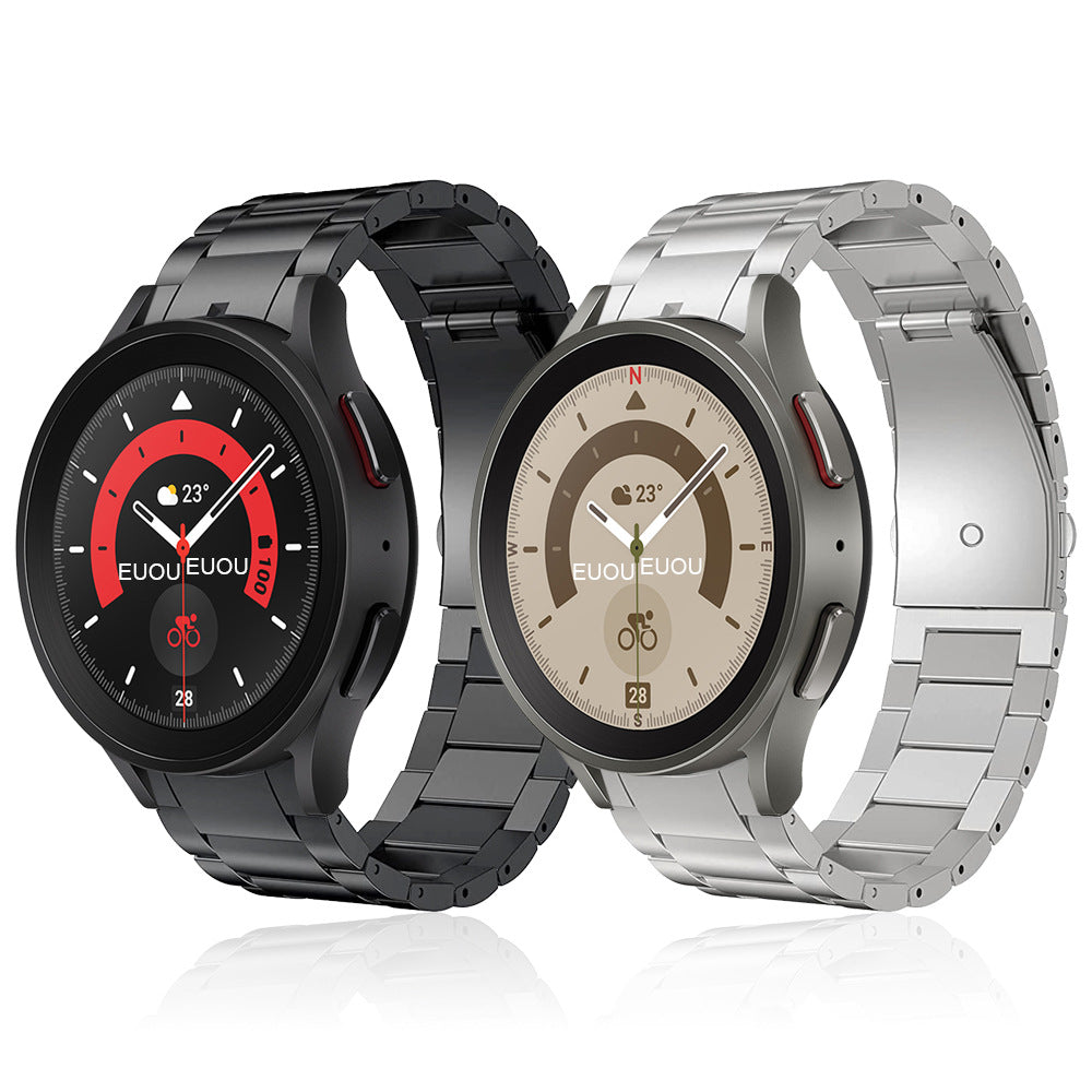 Pair of smartwatches with titanium bracelet bands in black and silver, displaying analog dials with temperature readings