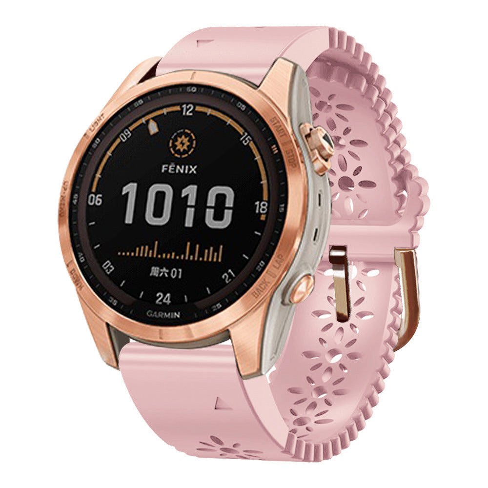 Fenix smartwatch with rose gold case, black digital display showing 1010 time, and pink silicone band with floral leaf pattern