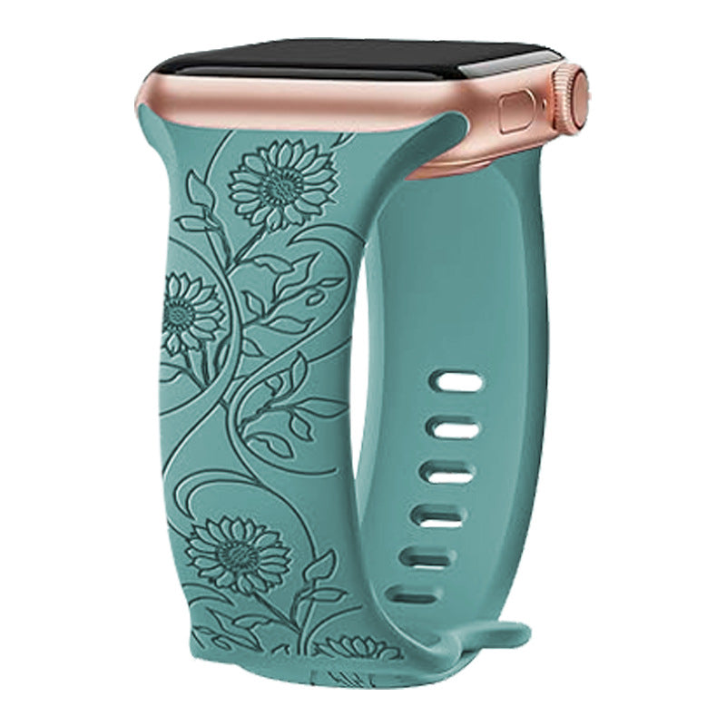 Turquoise silicone Apple Watch band with embossed floral sunflower design and rose gold connector hardware