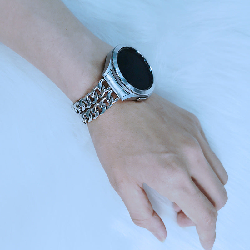 Silver chain link bracelet for Galaxy Watch 4-7 with black oval face on wrist against blue background