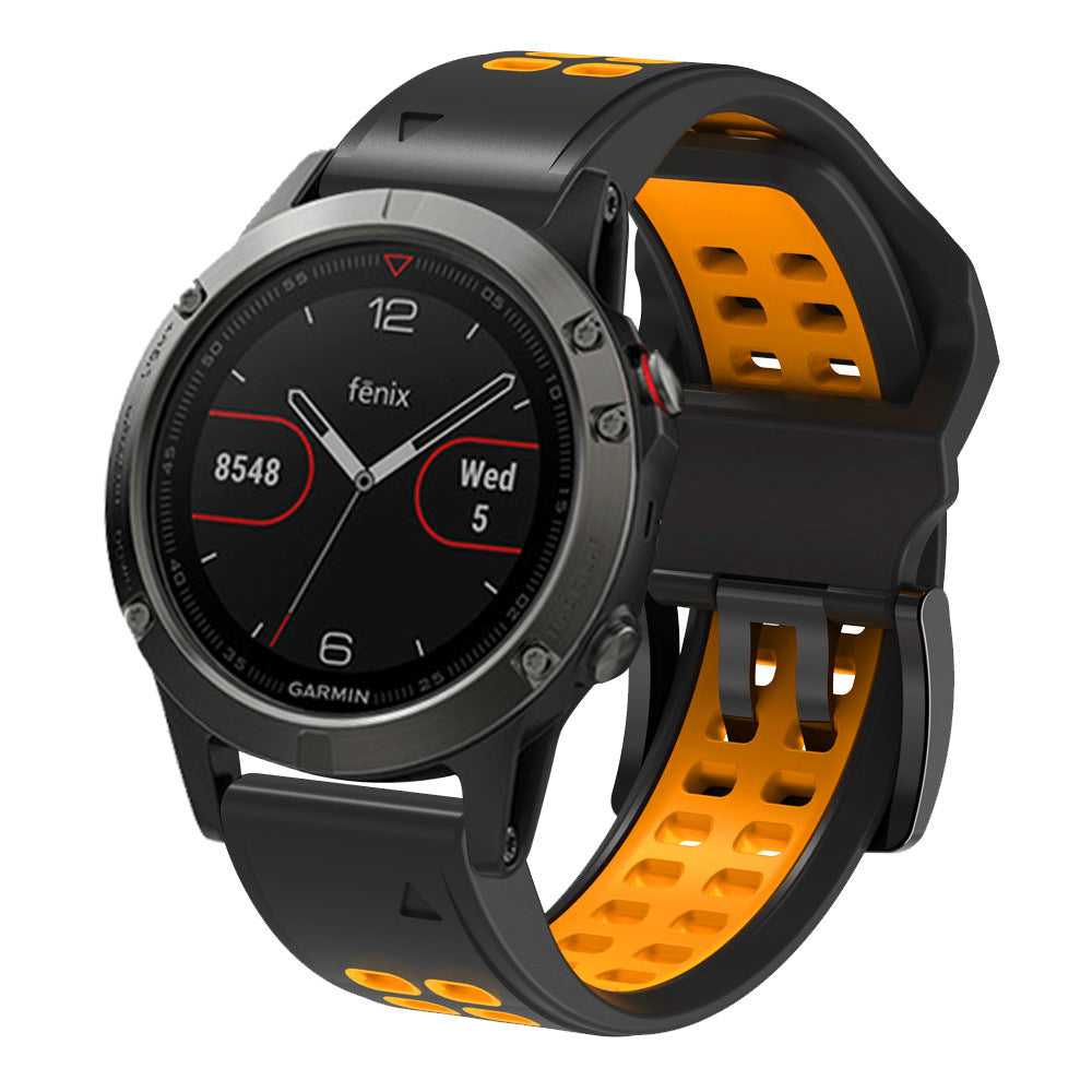 Garmin Fenix smartwatch with black dial and orange QuickFit silicone sports band, showing steps and date display