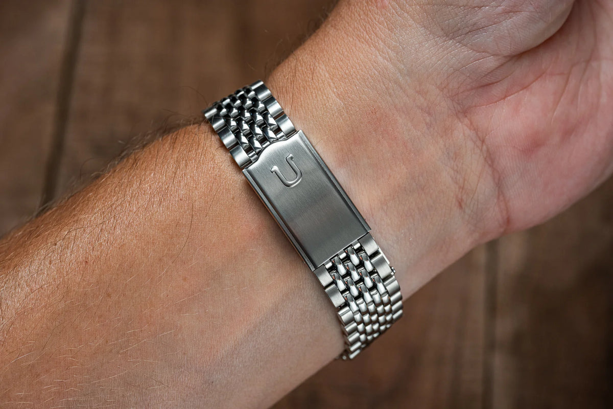 Stainless steel beads of rice bracelet with brushed rectangular clasp worn on wrist, compatible with Omega Constellation watches