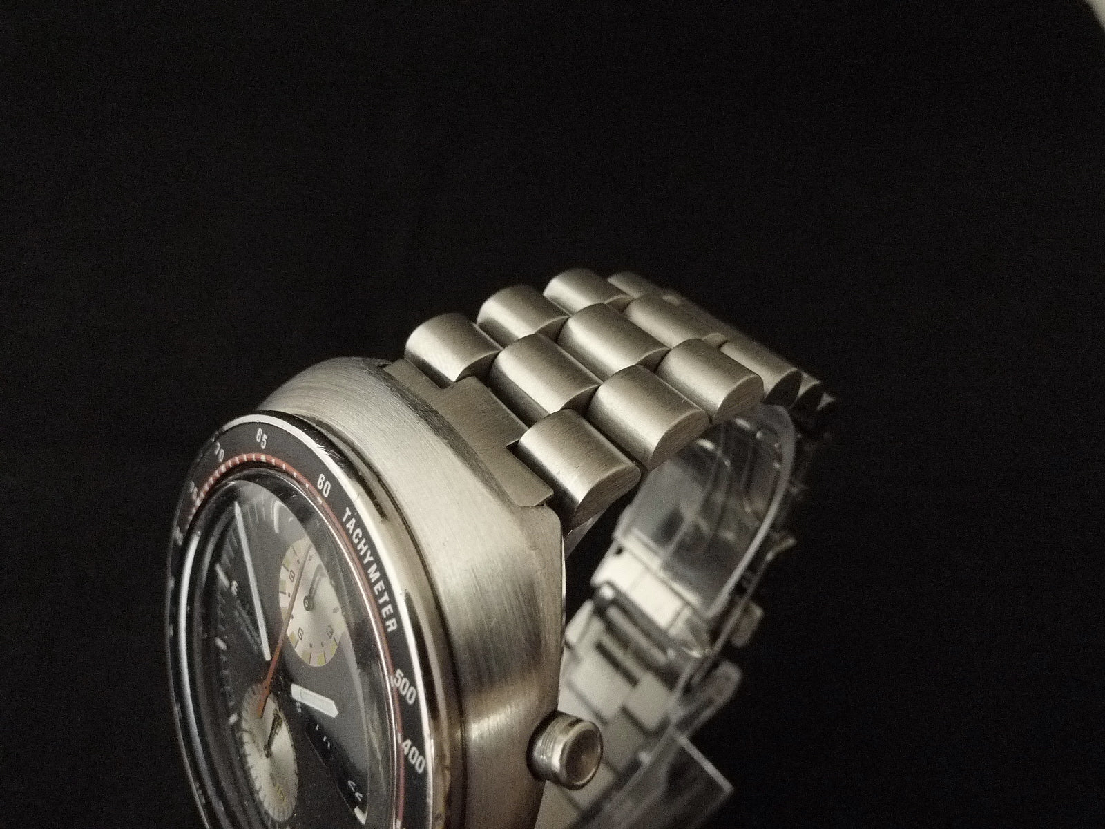 Seiko 6138 chronograph watch with brushed stainless steel case and matching metal bracelet on black background