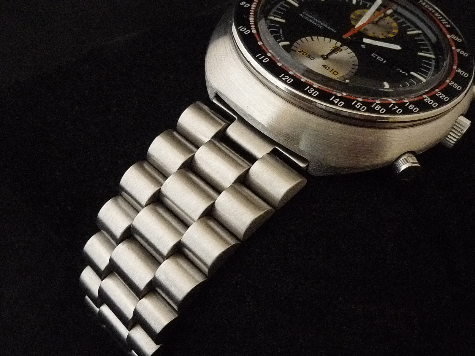 Vintage Seiko 6138 chronograph watch with stainless steel bracelet and black dial featuring tachymeter bezel