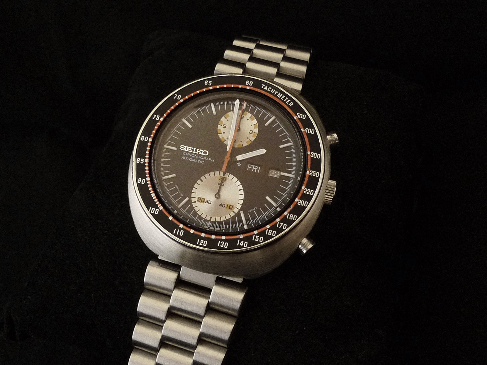 Seiko 6138 chronograph automatic watch with dark dial, tachymeter bezel, dual subdials, and stainless steel bracelet