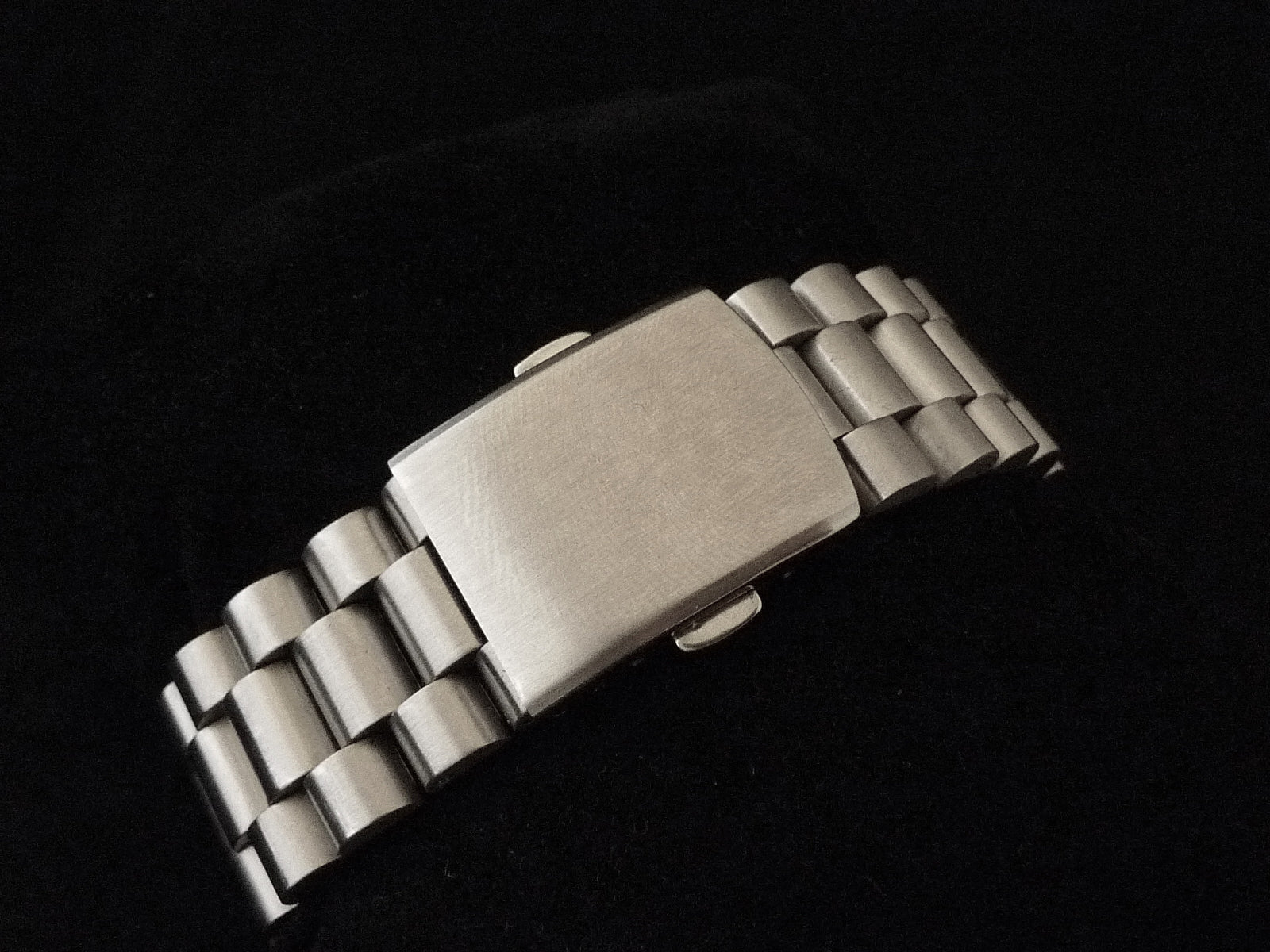 Stainless steel bracelet for Seiko 6138 Lincoln watch with polished center links and brushed outer links on black background