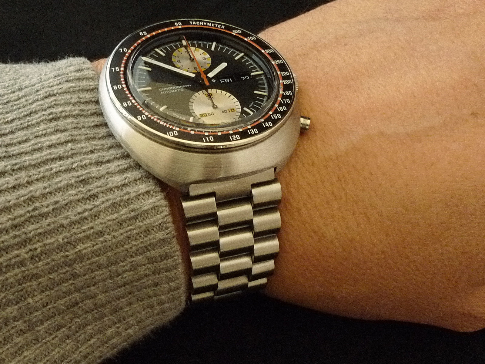 Vintage Seiko 6138 chronograph automatic watch with black dial, tachymeter bezel, and stainless steel bracelet on wrist