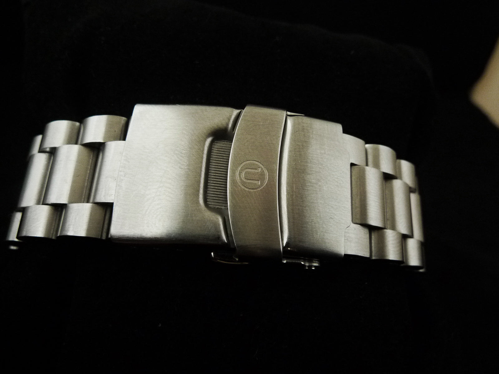 Stainless steel watch bracelet with solid links and fold-over clasp featuring Uncle logo for Seiko 6309 and SRP models