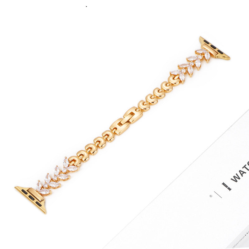 Gold cubic zirconia apple watch band with leaf-shaped crystal connectors and gold link chain design