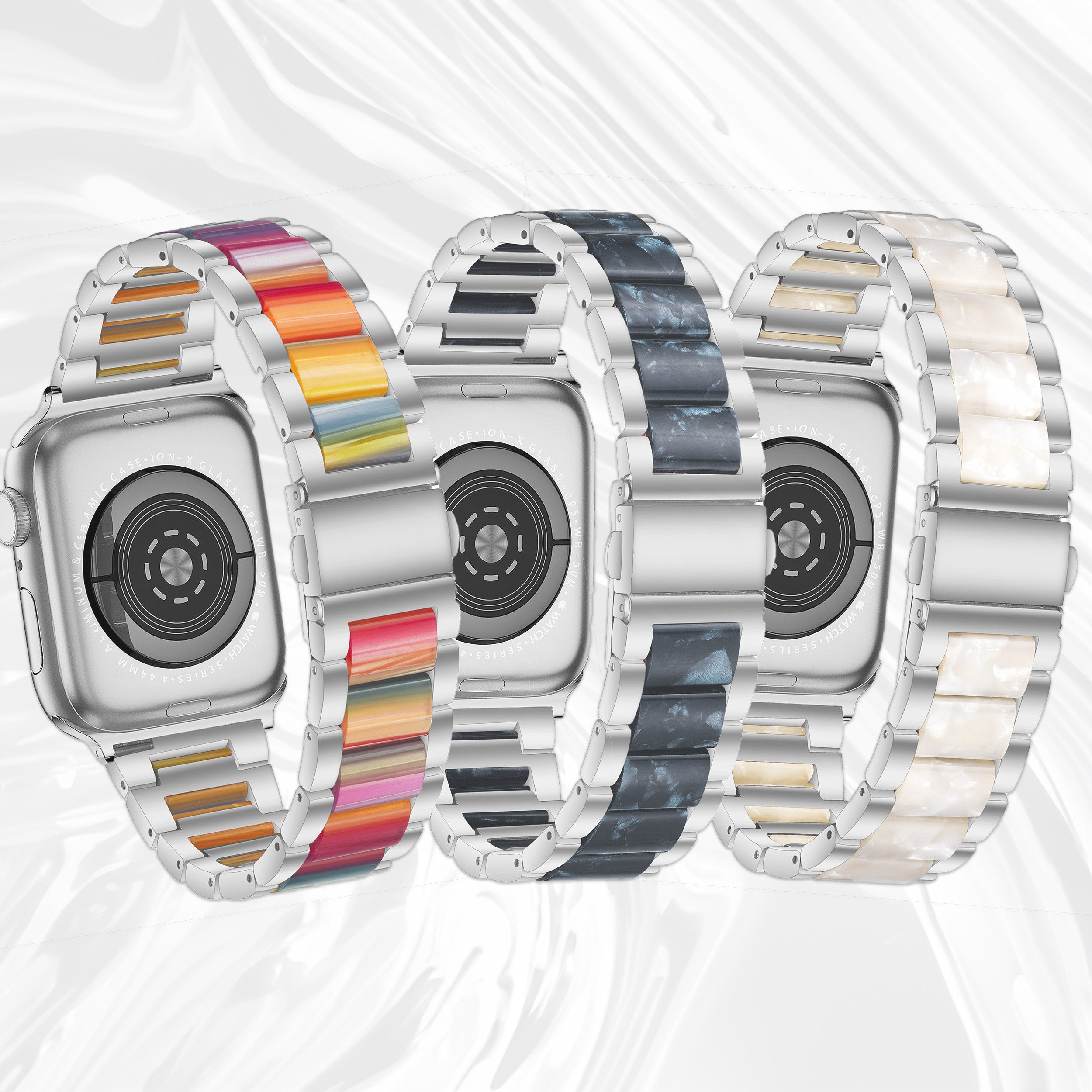 Three smartwatches with interchangeable metal bracelets in rainbow, marble, and pearl finishes
