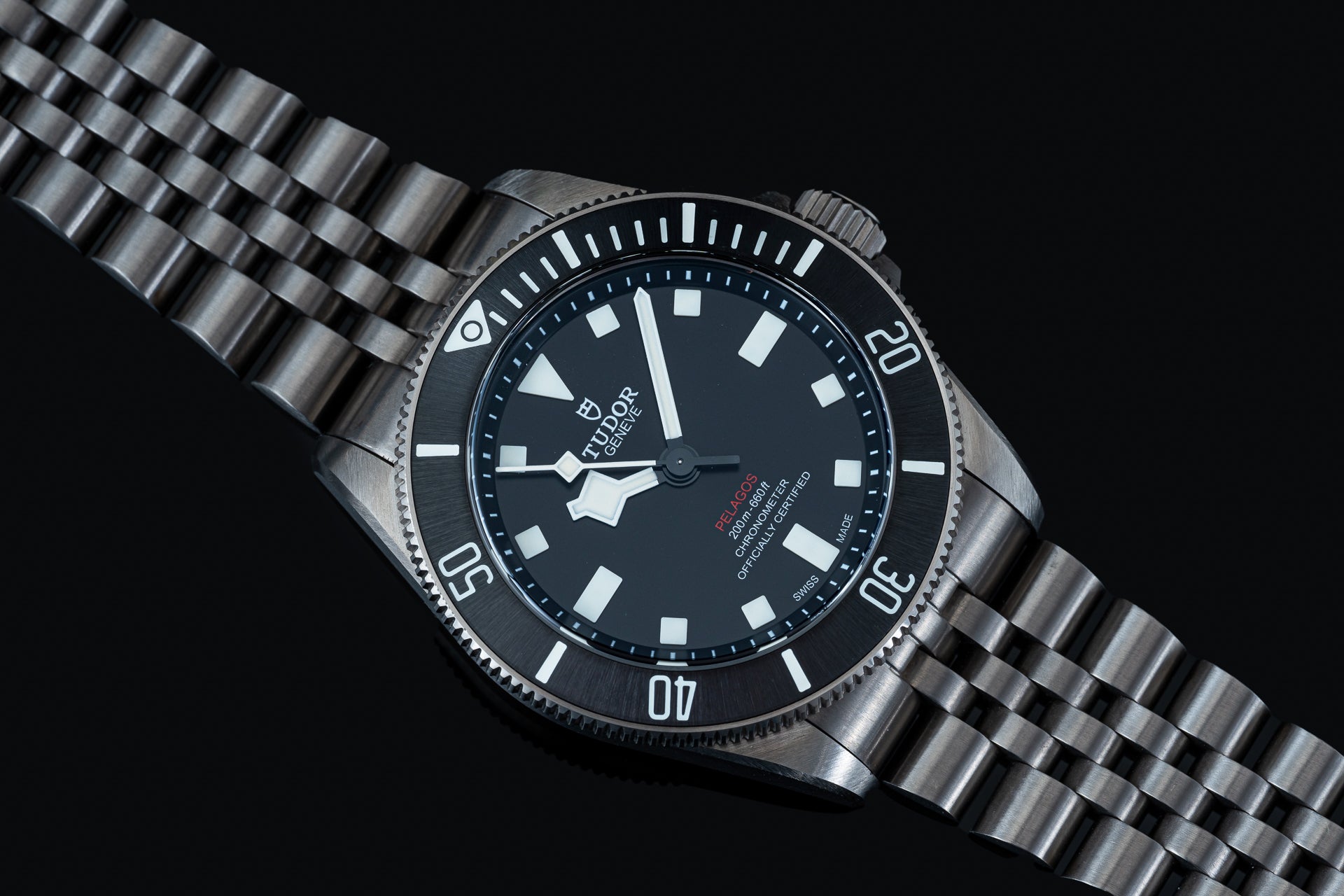 Titanium executive bracelet for Tudor Pelagos 39mm watch with polished links and secure clasp on black background