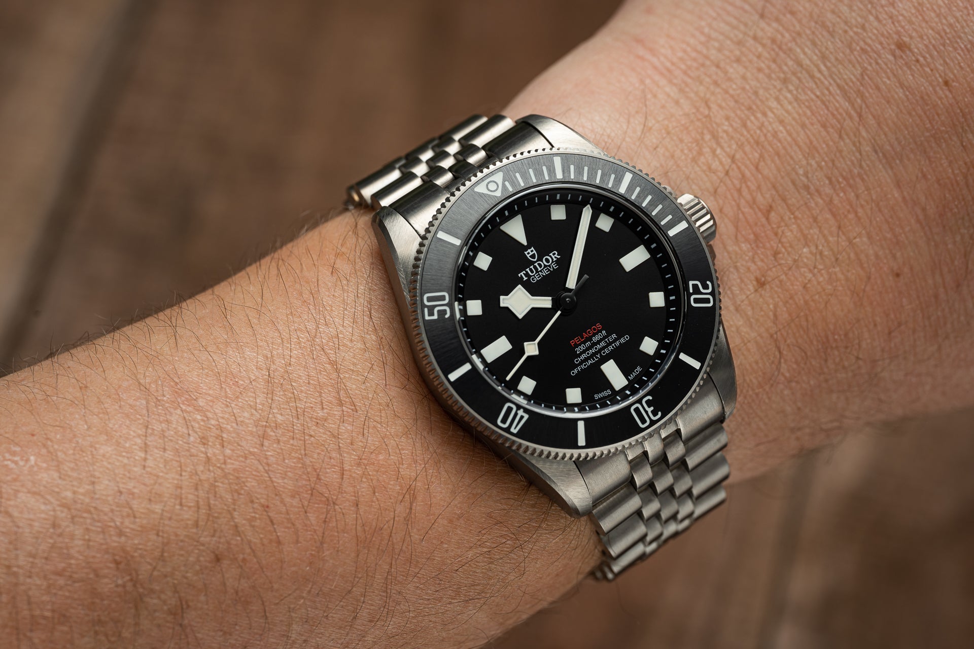 Tudor Pelagos 39mm stainless steel dive watch with black dial and bezel worn on wrist with metal bracelet