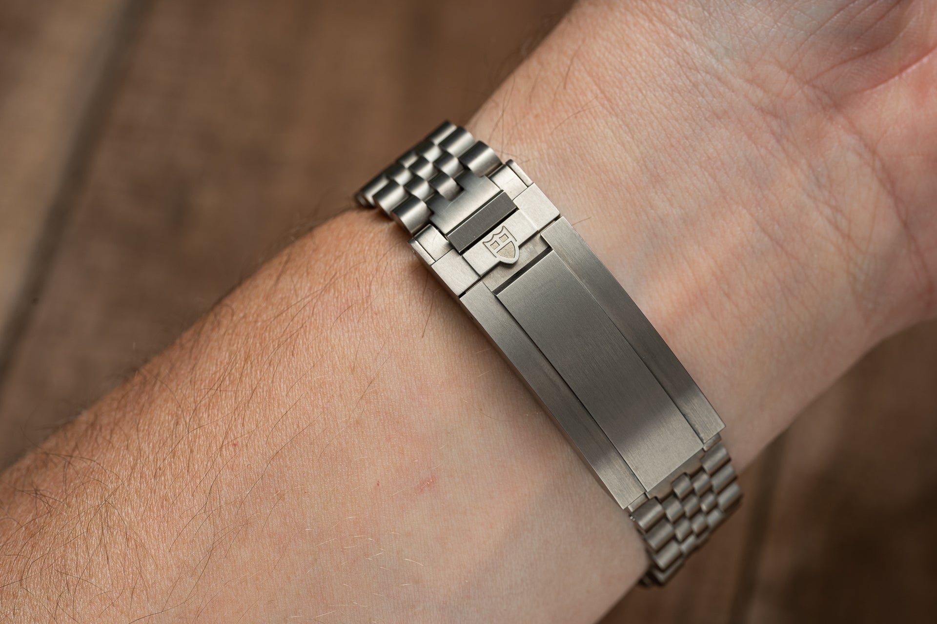 Stainless steel titanium executive bracelet with solid link design fitted on wrist, compatible with Tudor Pelagos 39mm watches