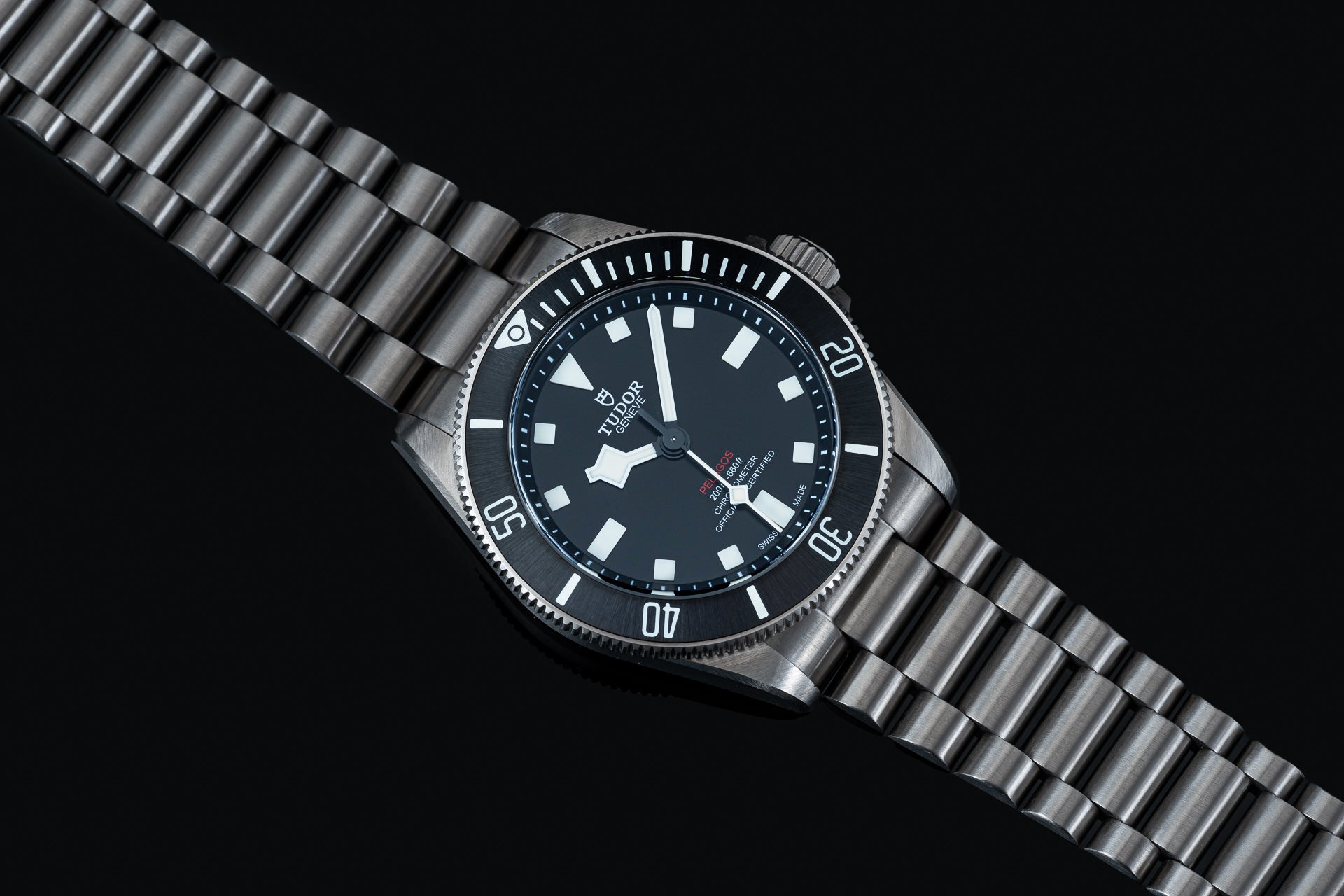 Titanium bracelet with solid links for Tudor Pelagos 39mm dive watch, featuring polished and brushed finish on black background