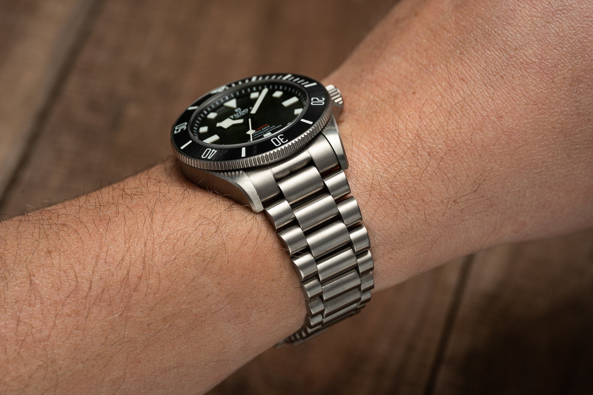 Stainless steel bracelet with solid link design fitted on wrist, featuring polished and brushed finish, compatible with Tudor Pelagos 39mm dive watch