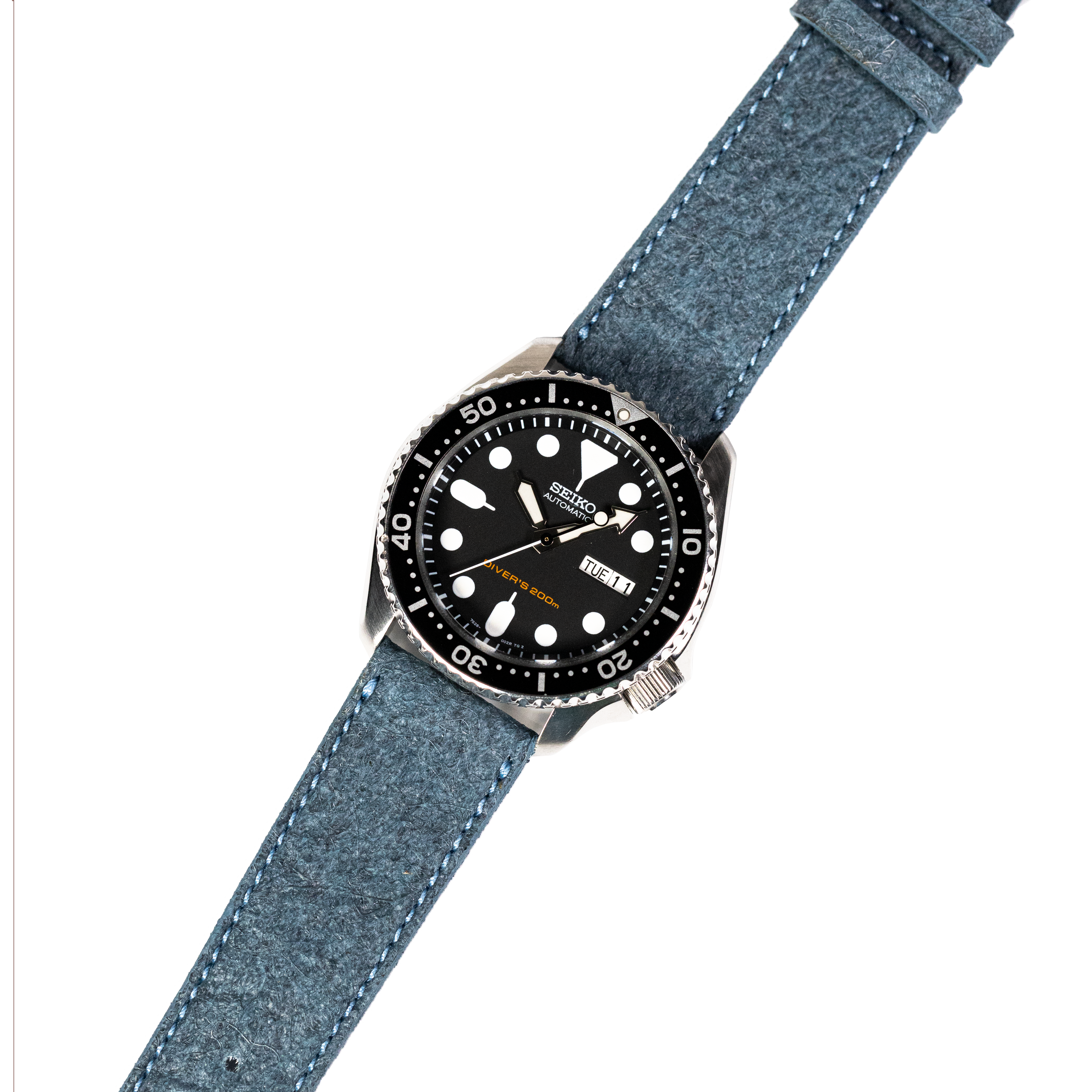 Seiko 5 Sports dive watch with black dial and luminous markers on blue fabric strap