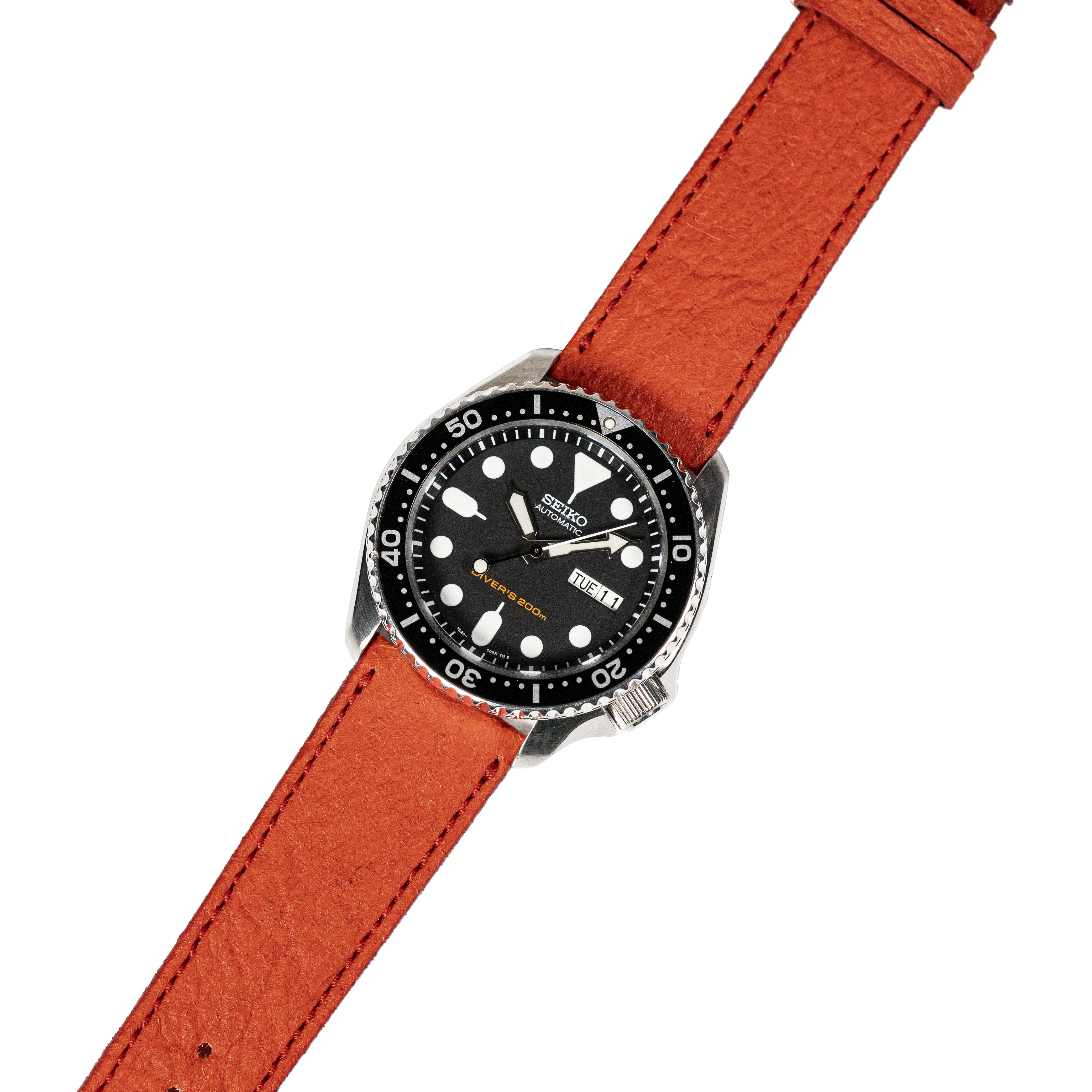 Seiko dive watch with black dial and orange suede leather strap, day-date window, rotating bezel