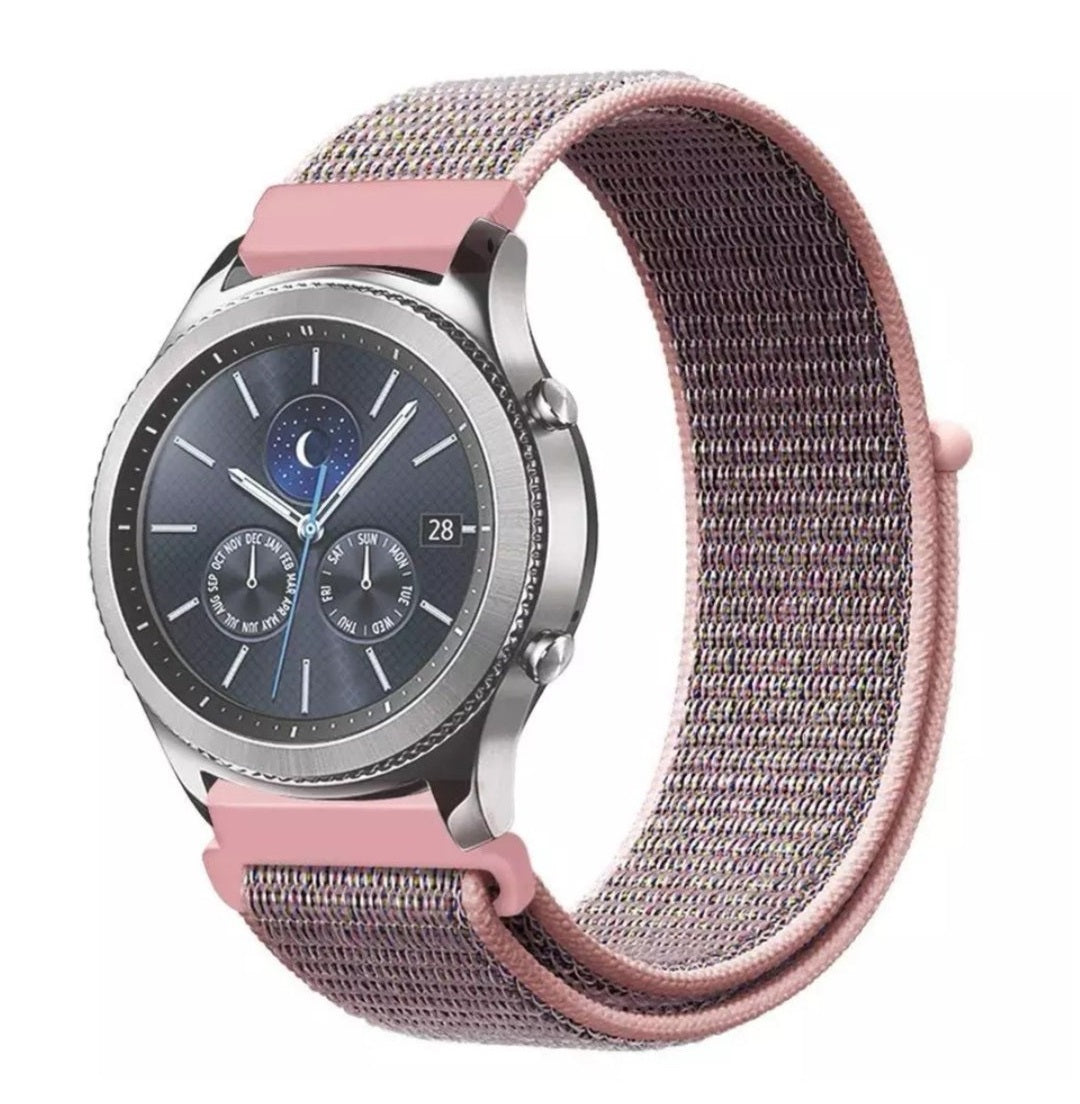 Pink woven sports loop velcro watch band with quick release for smartwatch, displayed on silver chronograph watch with dark dial