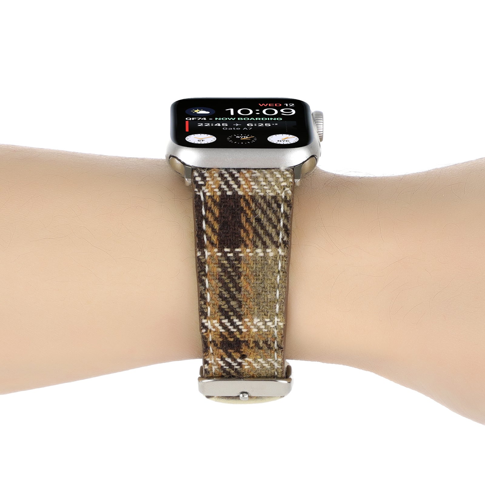 Silver Apple Watch with plaid check fabric band in brown, tan and cream on wrist displaying time and notifications