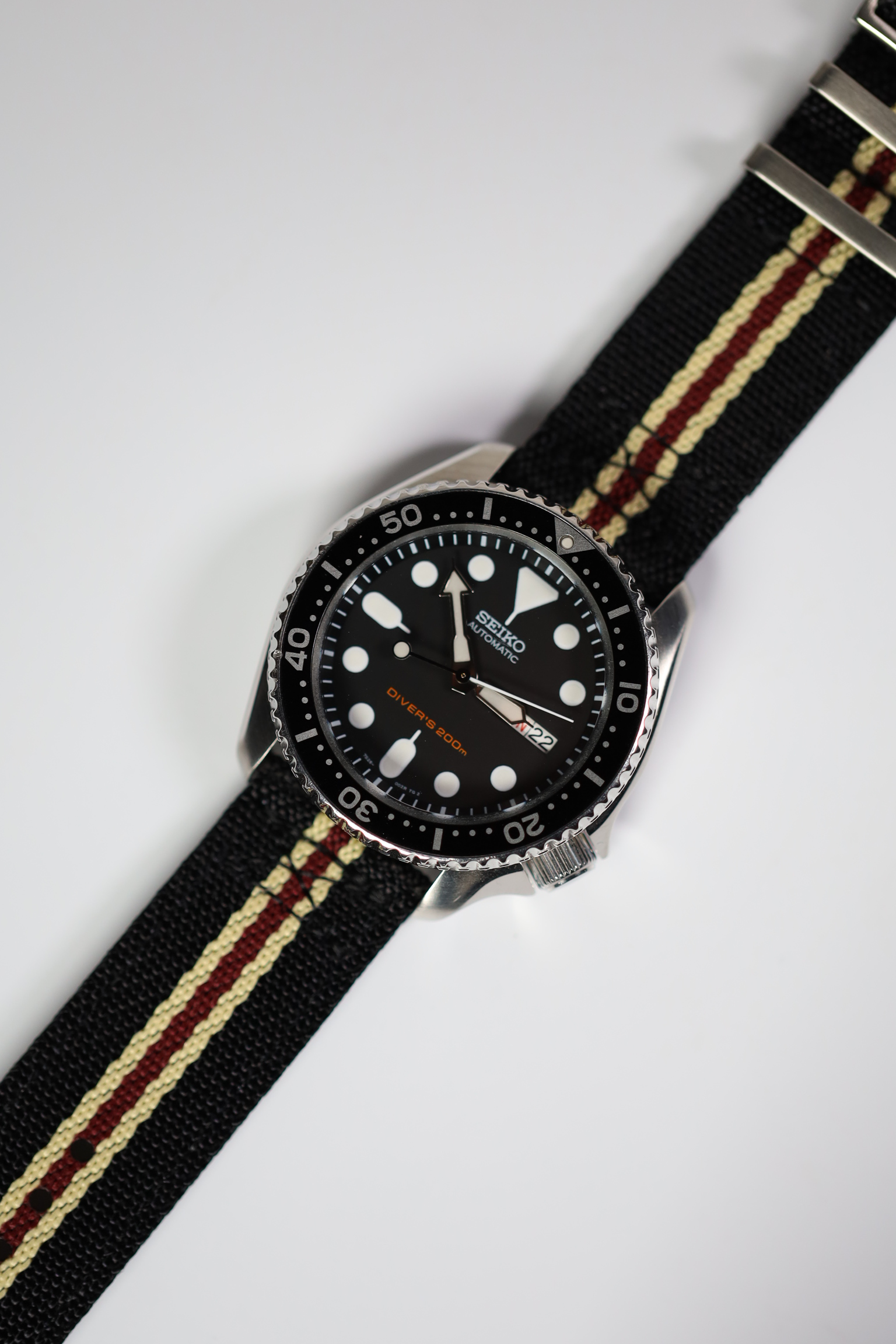 Black beige maroon cross NATO watch strap on watch