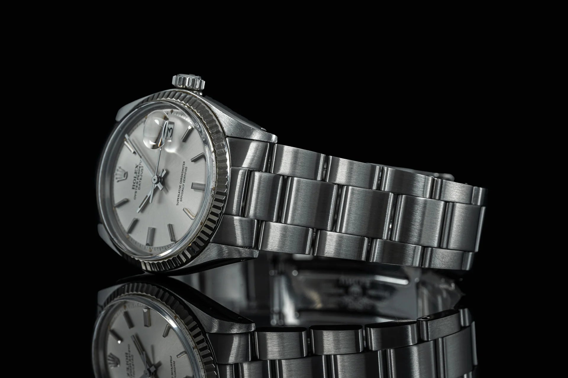 Vintage Rolex Datejust 1601 1603 stainless steel watch with Senator bracelet on black background